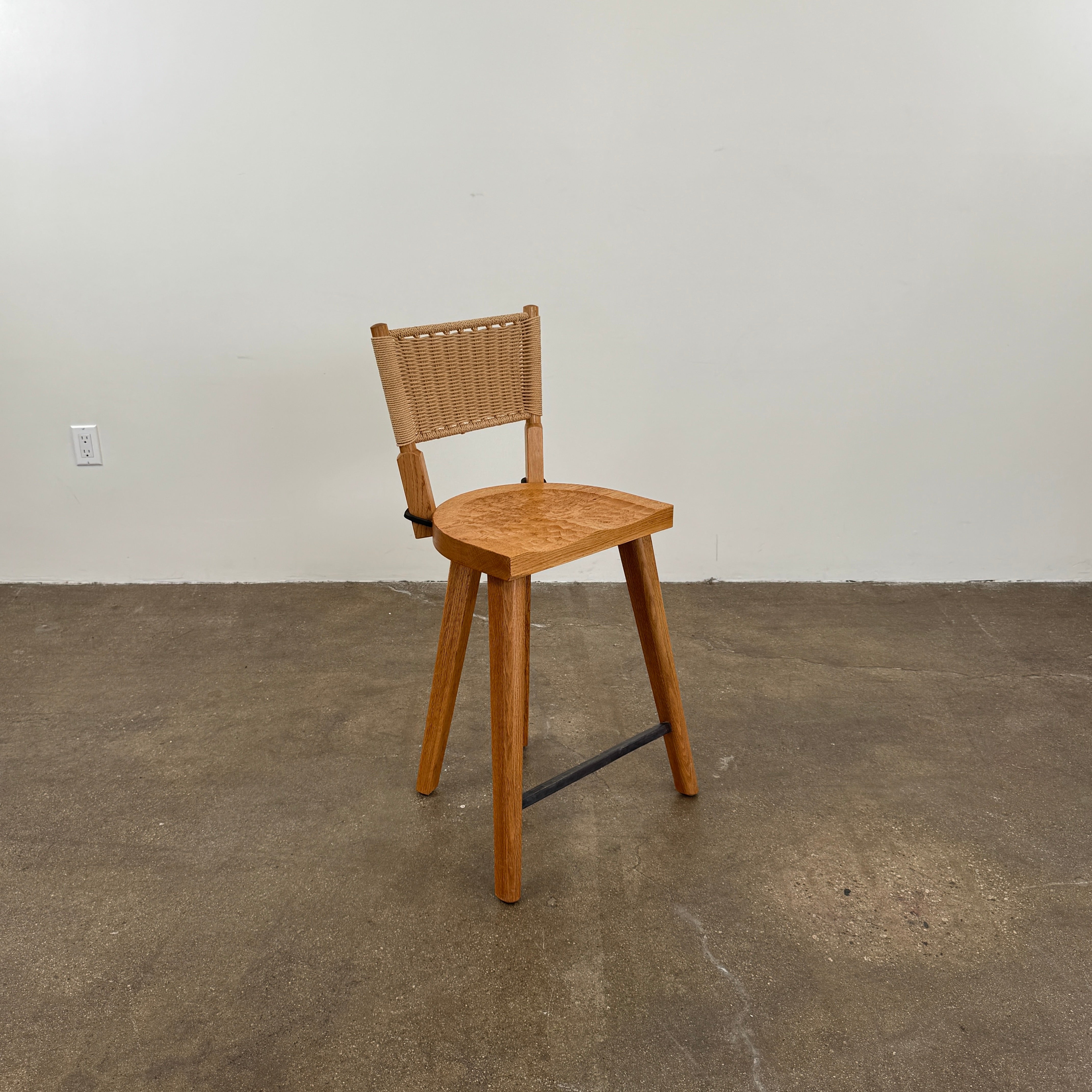 The Furniture Marolles Counter Stool Set of 3 by Furniture Marolles, featuring wooden construction and woven backrests inspired by handcrafted design, is arranged side by side against a plain white background.