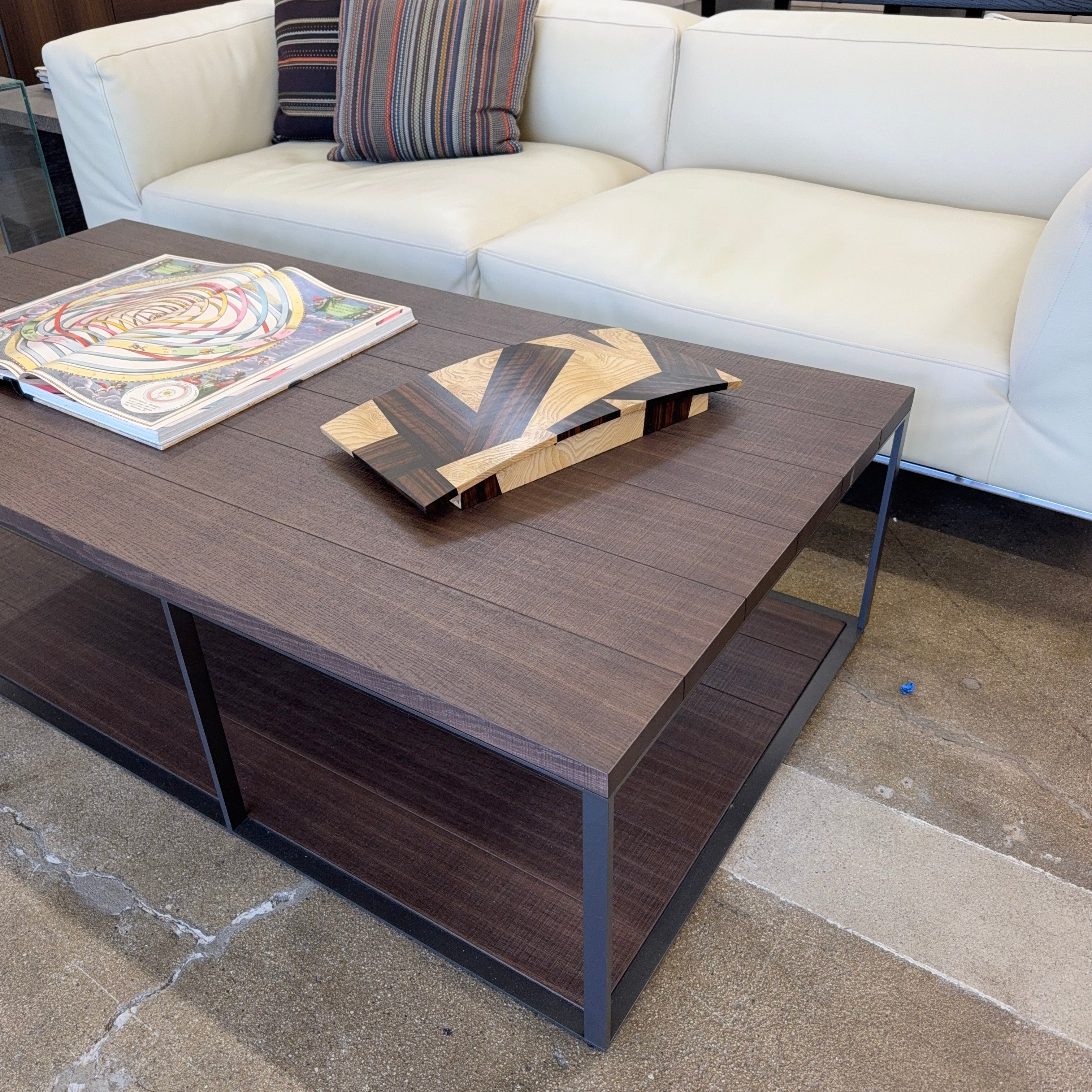 A rectangular table top storage box by Mike Fair Custom Furnishings, crafted from luxurious Macassar Ebony and Ash Burl with a geometric patterned lid, is displayed open to reveal a foam insert inside. The elegant Mike Fair Table Top Storage Box rests on a light fabric surface.