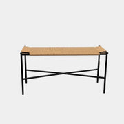 Fritz Hansen Skagerak VENT Bench by Fritz Hansen, featuring a rectangular black metal frame with minimalist crossed supports underneath and a woven tan paper cord seat, shown on a plain white background.