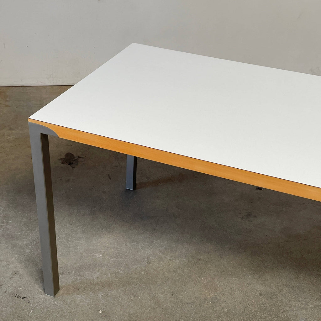 A Driade On Land dining table with a white top and metal legs.