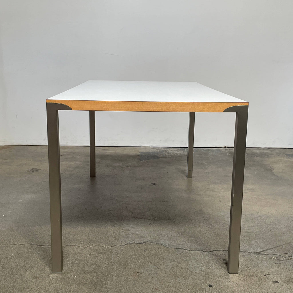 A Driade On Land dining table with a white top and metal legs.
