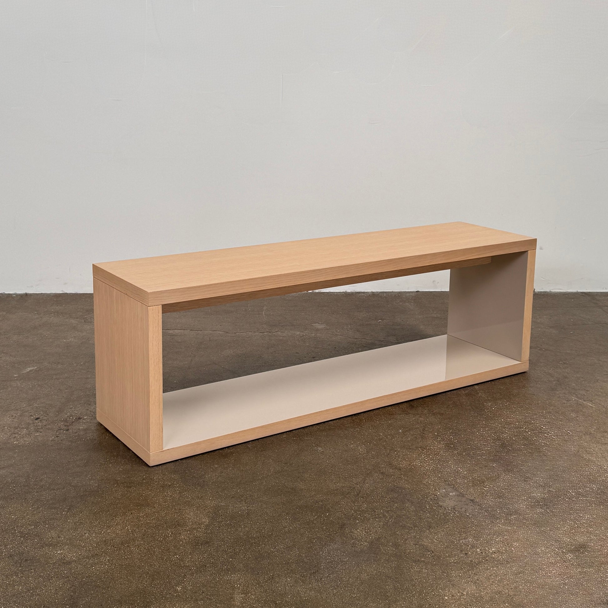 The B&B Italia Frank Low Console by B&B Italia rests on a polished concrete floor against a plain white wall.