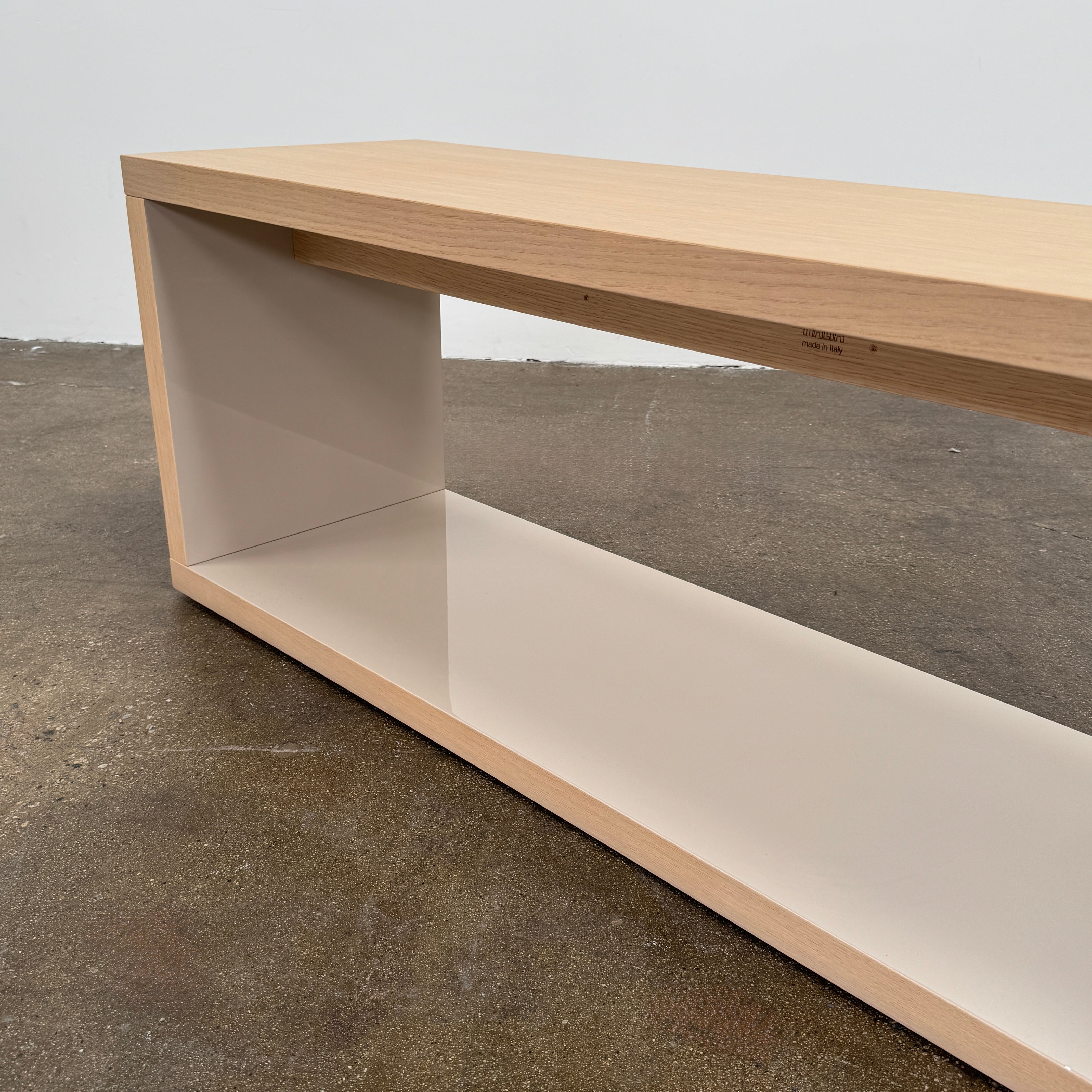 The B&B Italia Frank Low Console by B&B Italia rests on a polished concrete floor against a plain white wall.