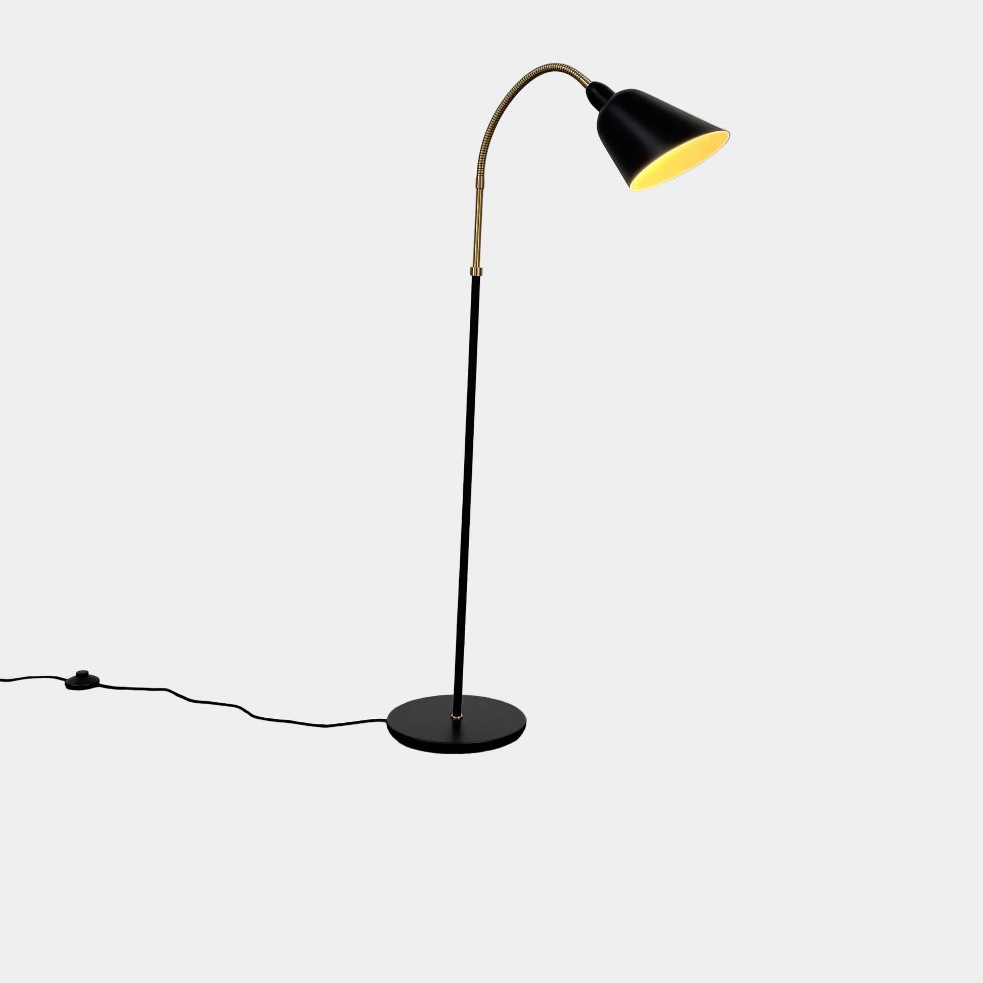 Close-up of a lamp label displaying model details—230V Max 60W E27, IP20—and manufacturer information above a black lamp socket, an elegant detail characteristic of the &Tradition Bellevue Floor Lamp AJ7 by &Tradition, a design that exemplifies Arne Jacobsen’s influential contribution to Scandinavian modernism.
