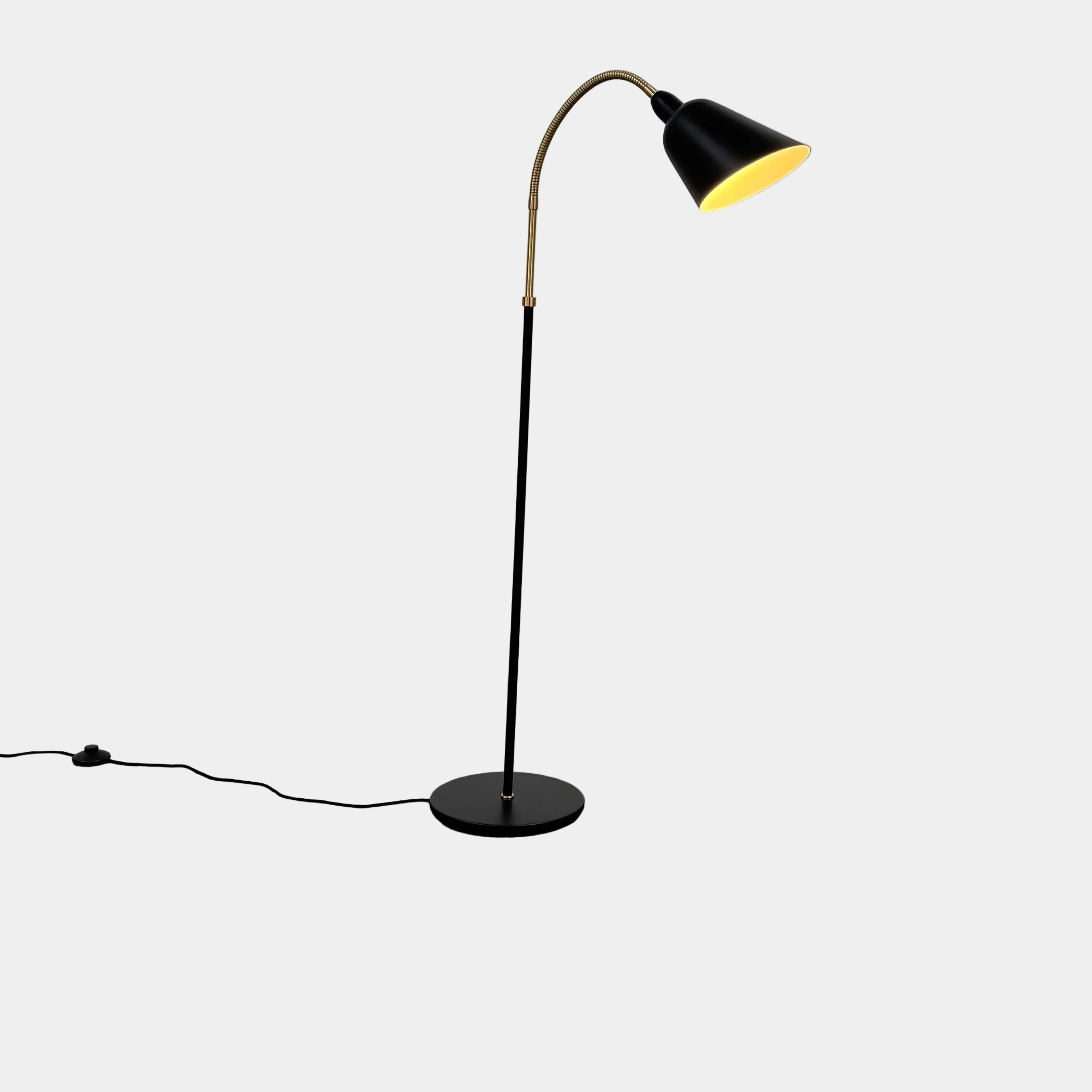 Close-up of a lamp label displaying model details—230V Max 60W E27, IP20—and manufacturer information above a black lamp socket, an elegant detail characteristic of the &Tradition Bellevue Floor Lamp AJ7 by &Tradition, a design that exemplifies Arne Jacobsen’s influential contribution to Scandinavian modernism.
