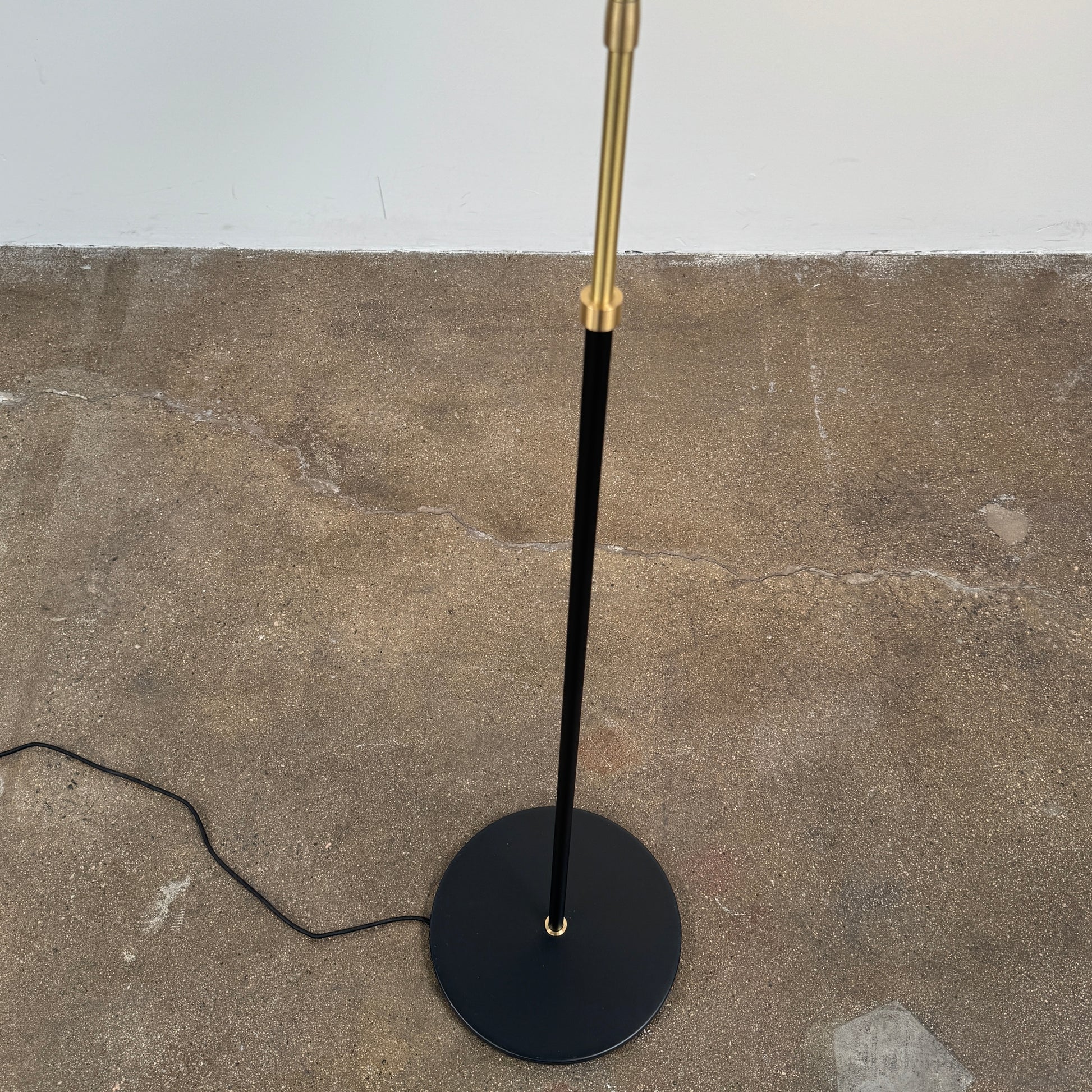 Close-up of a lamp label displaying model details—230V Max 60W E27, IP20—and manufacturer information above a black lamp socket, an elegant detail characteristic of the &Tradition Bellevue Floor Lamp AJ7 by &Tradition, a design that exemplifies Arne Jacobsen’s influential contribution to Scandinavian modernism.