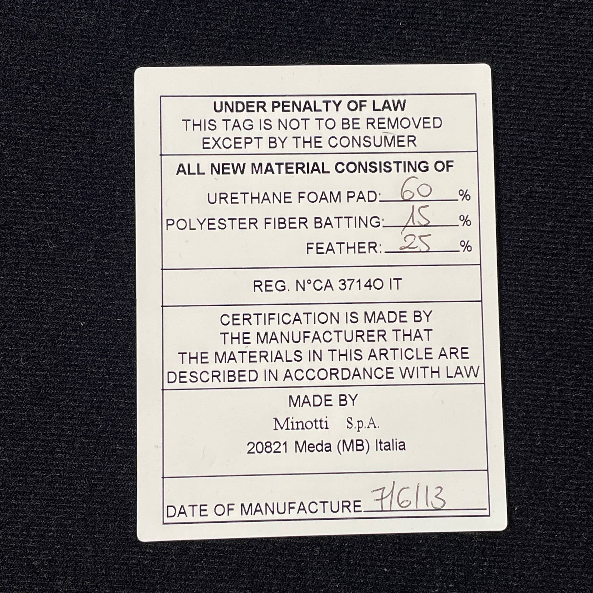 A Minotti Powell Sectional Sofa with black pillows from Minotti.