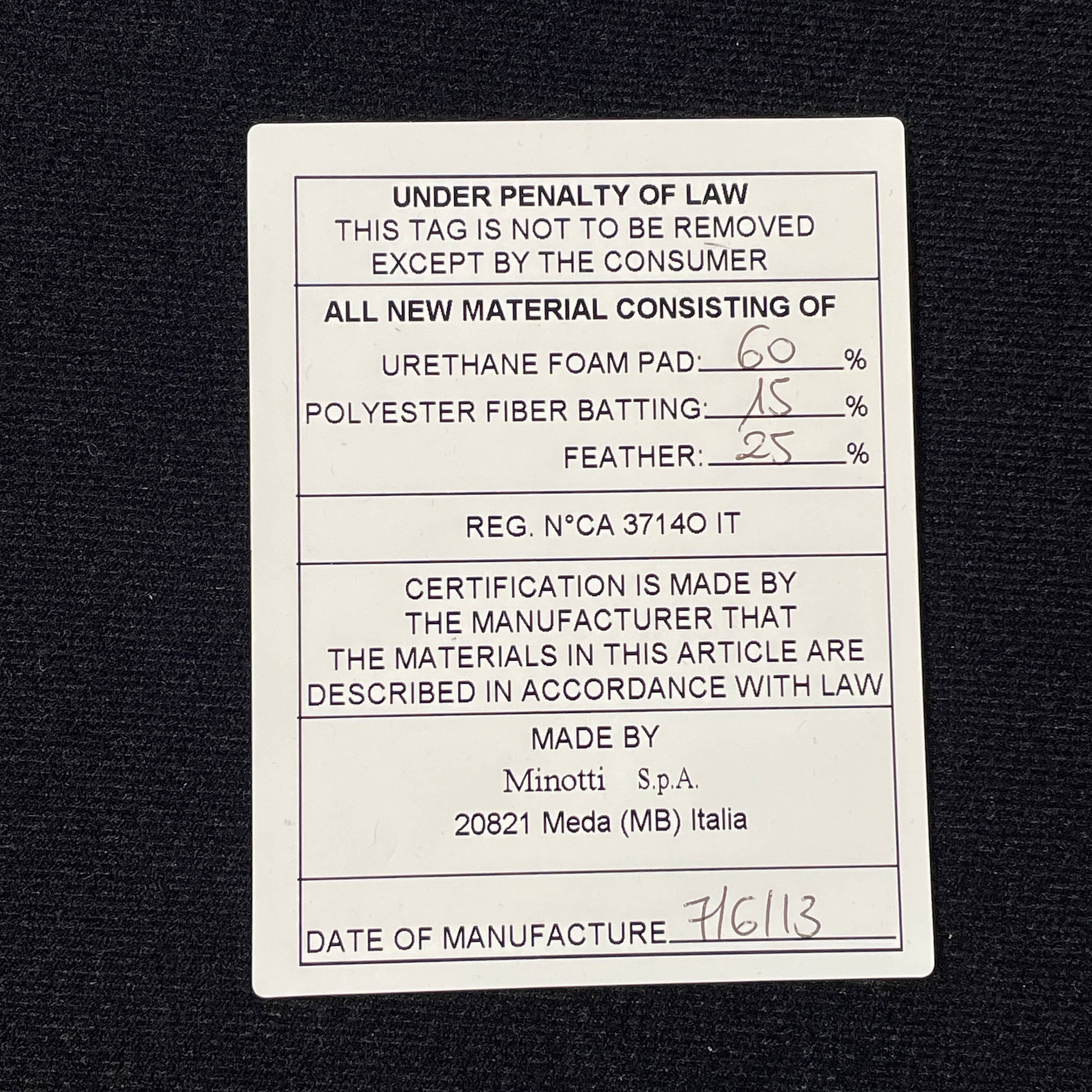 A Minotti Powell Sectional Sofa with black pillows from Minotti.