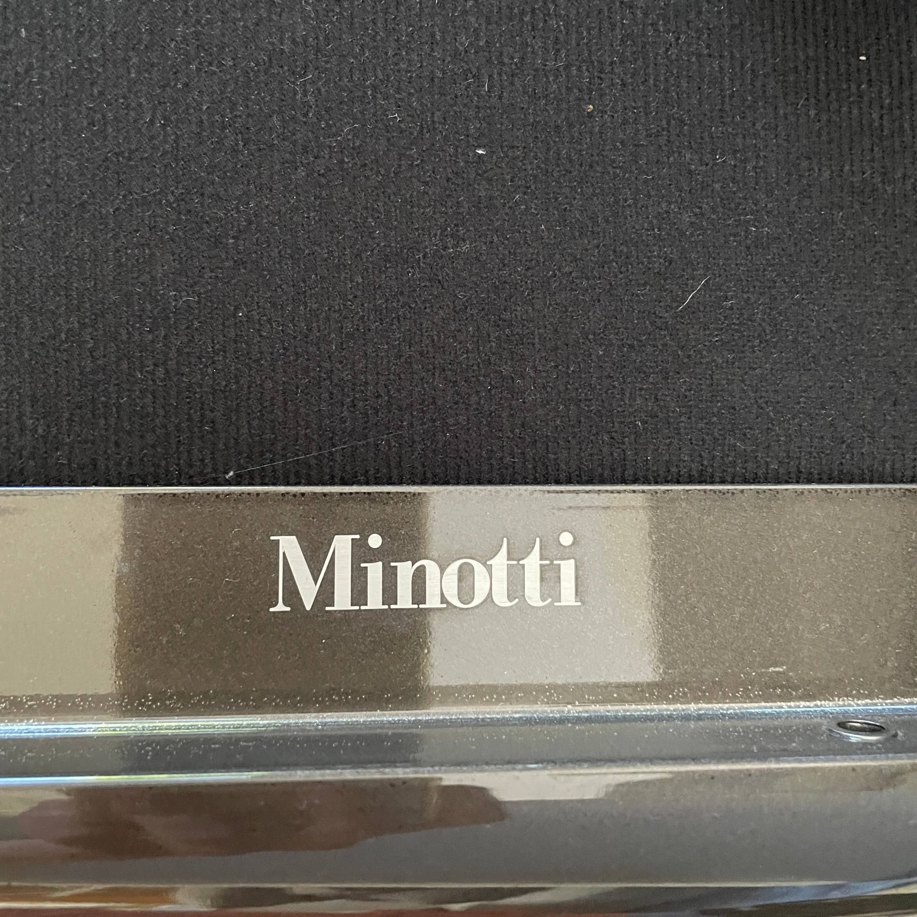 A Minotti Powell Sectional Sofa with black pillows from Minotti.