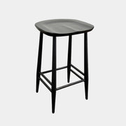 The Ercol Originals Counter Stool in Black Ash, crafted by Ercol, features four legs, a square contoured seat, and footrests on two sides. Set against a plain white background, this piece showcases the timeless craftsmanship of handmade British furniture.