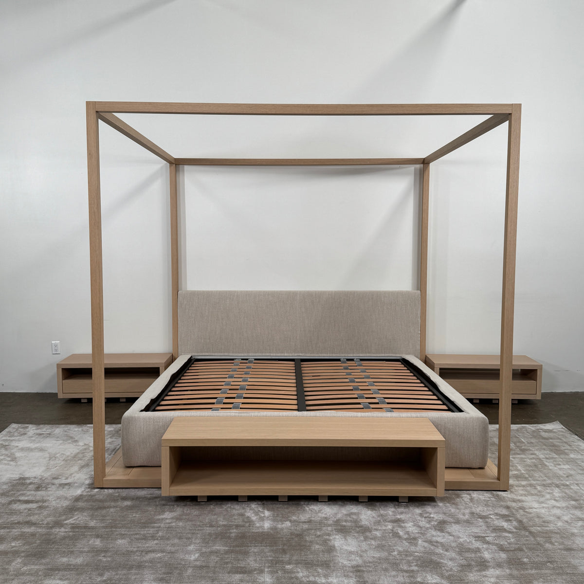 The Maxalto Alcova King Bed with Bench and Nightstands by Maxalto showcases a refined wooden structure, an upholstered headboard, and a slatted mattress base, capturing modern canopy bed design inspired by Antonio Citterio—displayed against a plain white background.