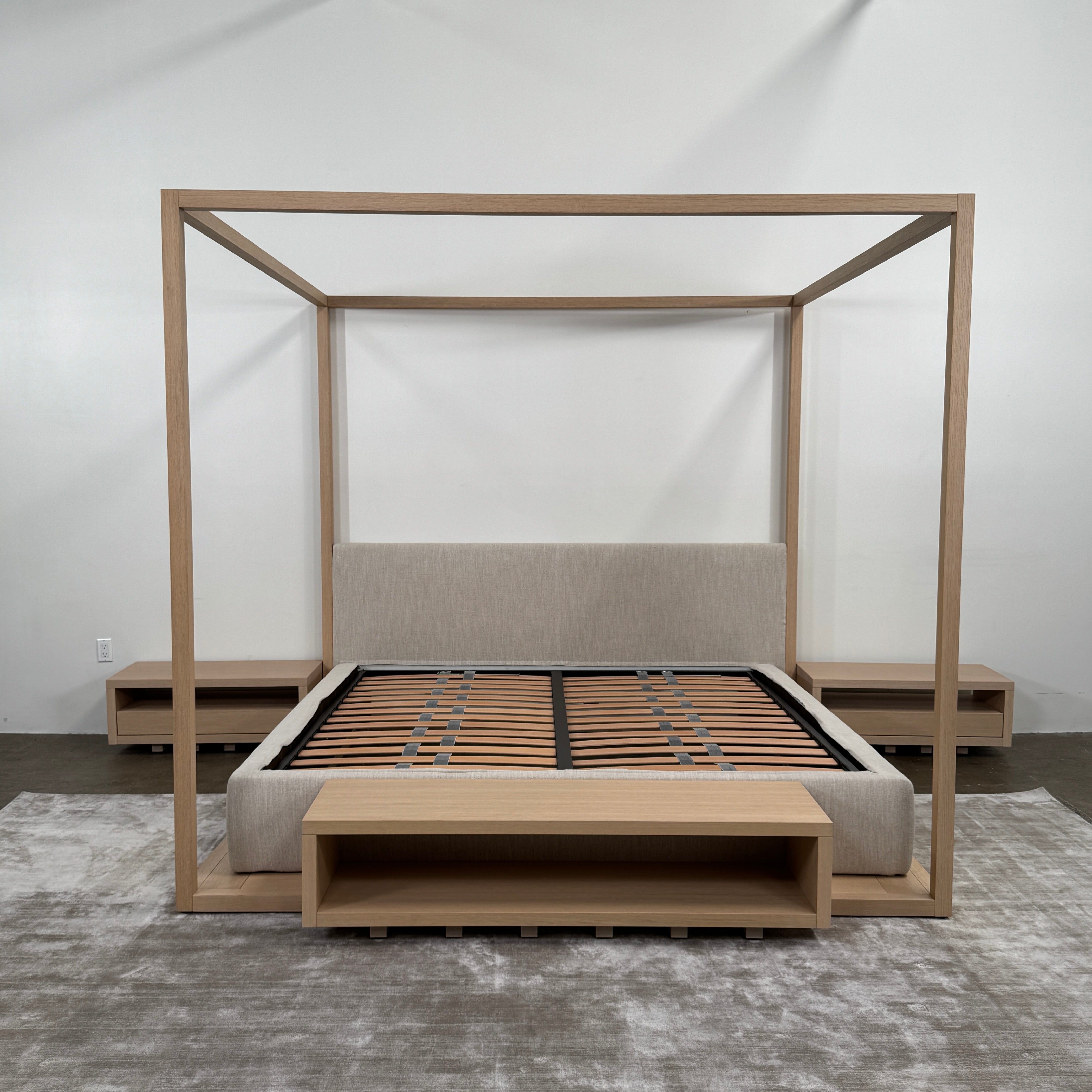 The Maxalto Alcova King Bed with Bench and Nightstands by Maxalto showcases a refined wooden structure, an upholstered headboard, and a slatted mattress base, capturing modern canopy bed design inspired by Antonio Citterio—displayed against a plain white background.