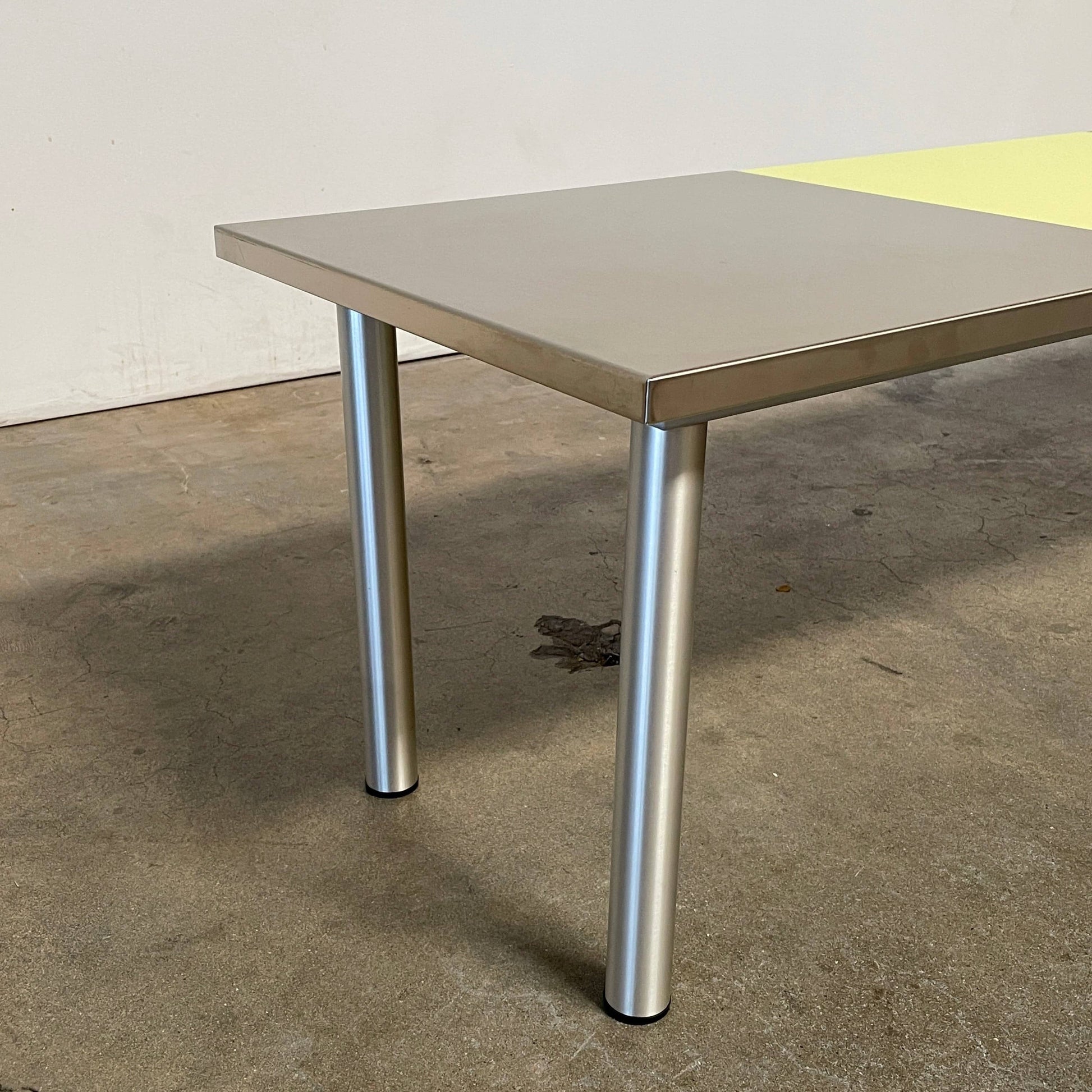 The Mazzei Multi-Panel Table by Mazzei is a contemporary design featuring a bench with a vibrant yellow, green, and blue top that adds functionality to any space.