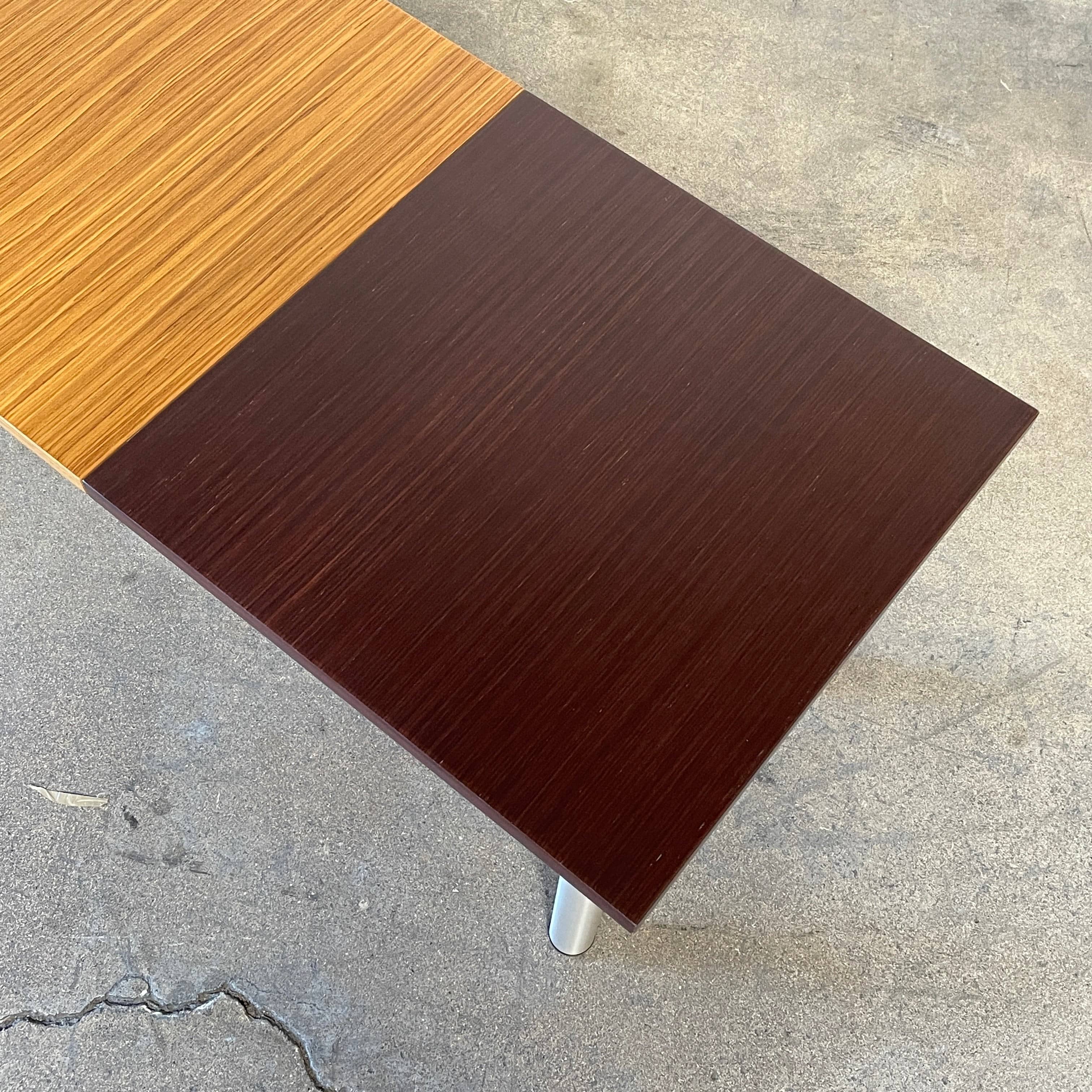 The Mazzei Multi-Panel Table by Mazzei is a contemporary design featuring a bench with a vibrant yellow, green, and blue top that adds functionality to any space.