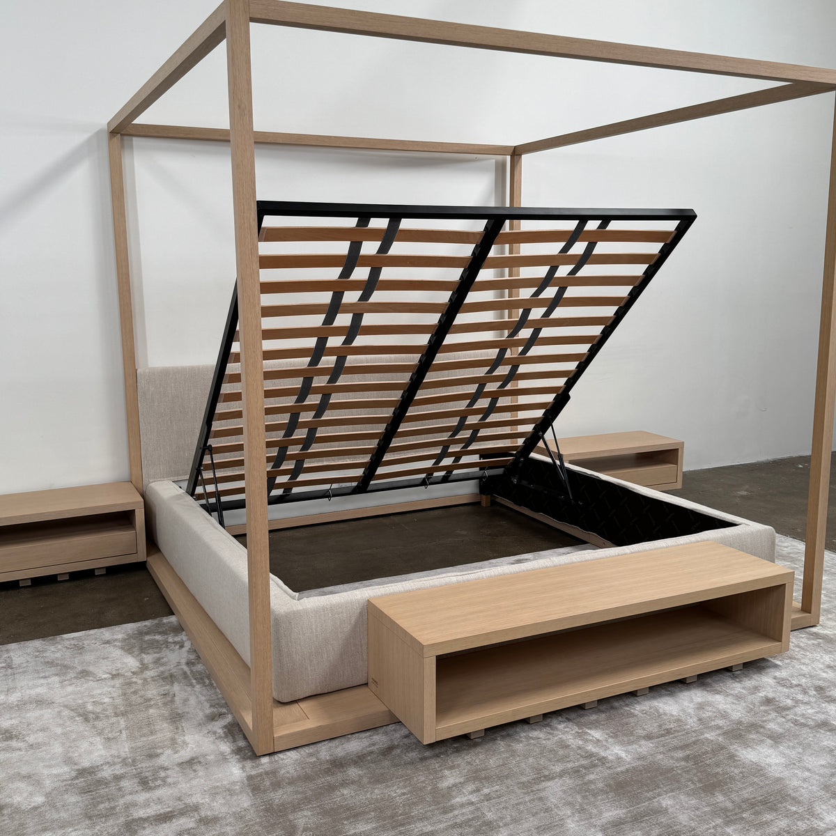 The Maxalto Alcova King Bed with Bench and Nightstands by Maxalto showcases a refined wooden structure, an upholstered headboard, and a slatted mattress base, capturing modern canopy bed design inspired by Antonio Citterio—displayed against a plain white background.