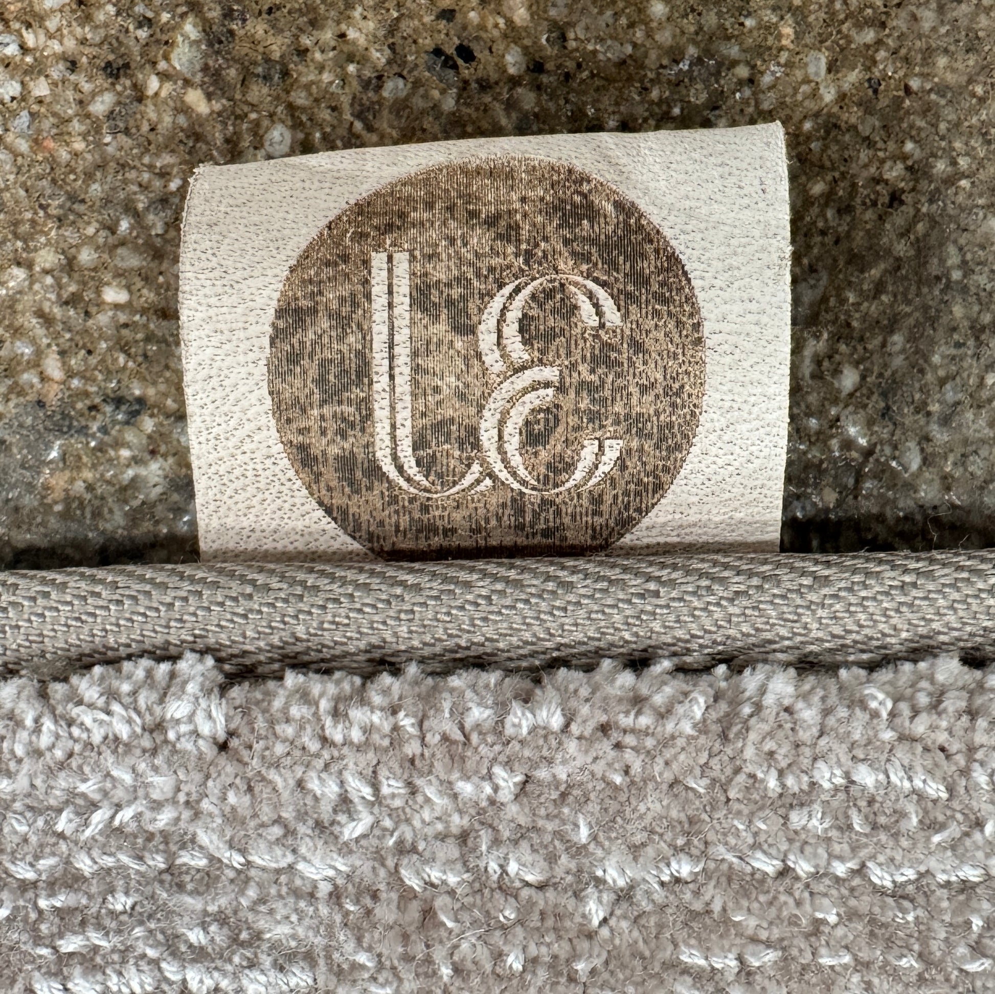 A close-up view of the Limited Edition 10 x 13.5′ Silk Rug, a rectangular, light gray area rug featuring a subtle textured pattern, crafted by the renowned Belgian brand Limited Edition. The luxurious silk rug is photographed against a plain white background.