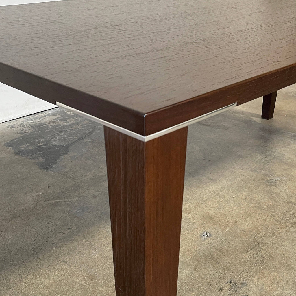A rectangular Fashion Dining Table made of wenge wood, featuring dark wood legs.