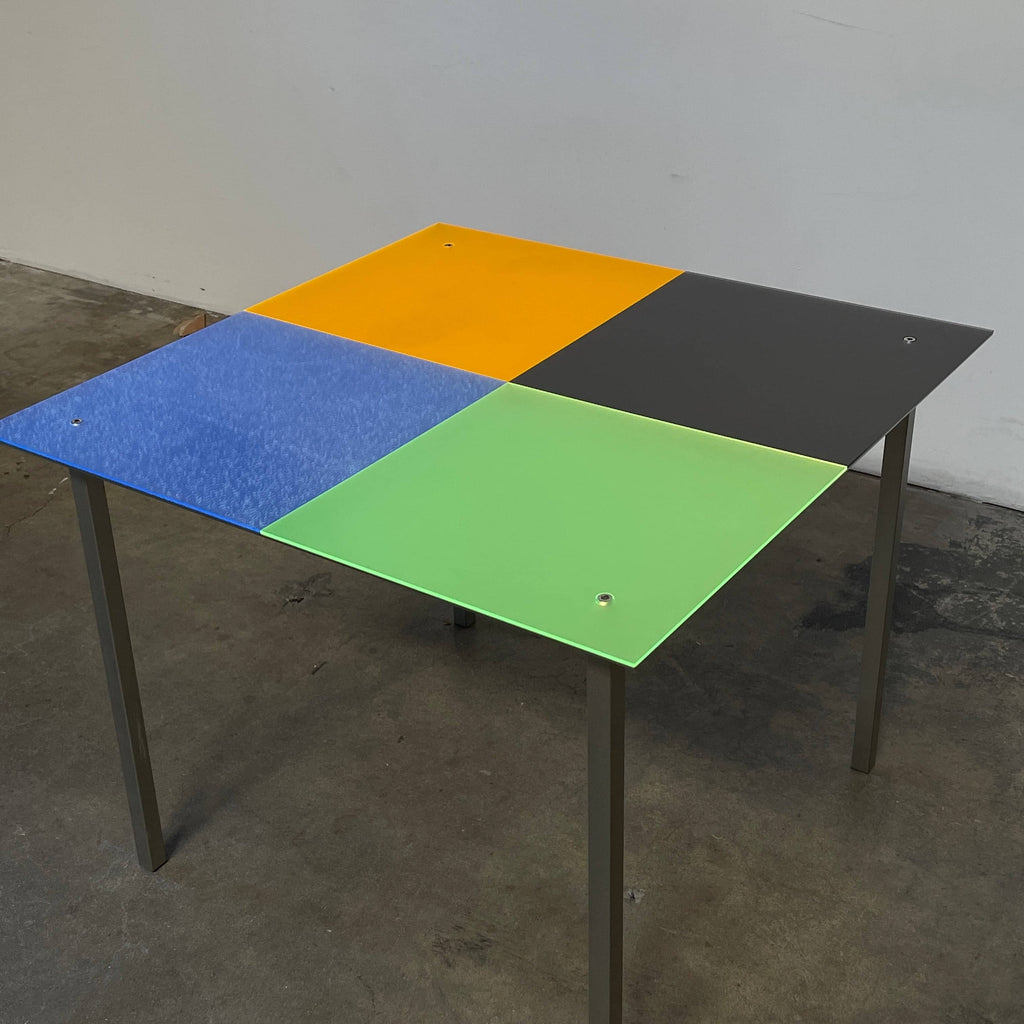 A Mazzei Multi-Colored Square Metal Table with a stainless steel frame.