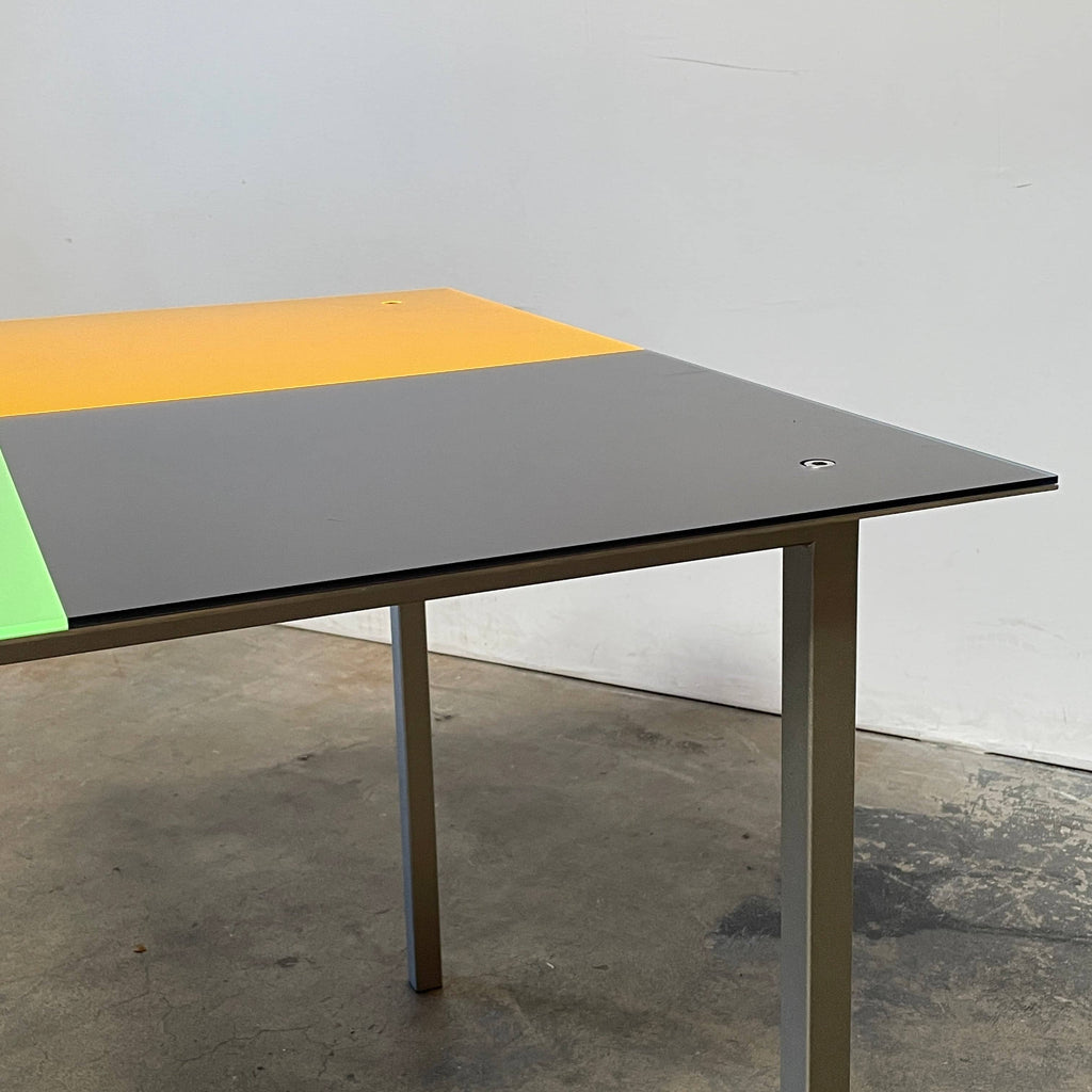 A Mazzei Multi-Colored Square Metal Table with a stainless steel frame.