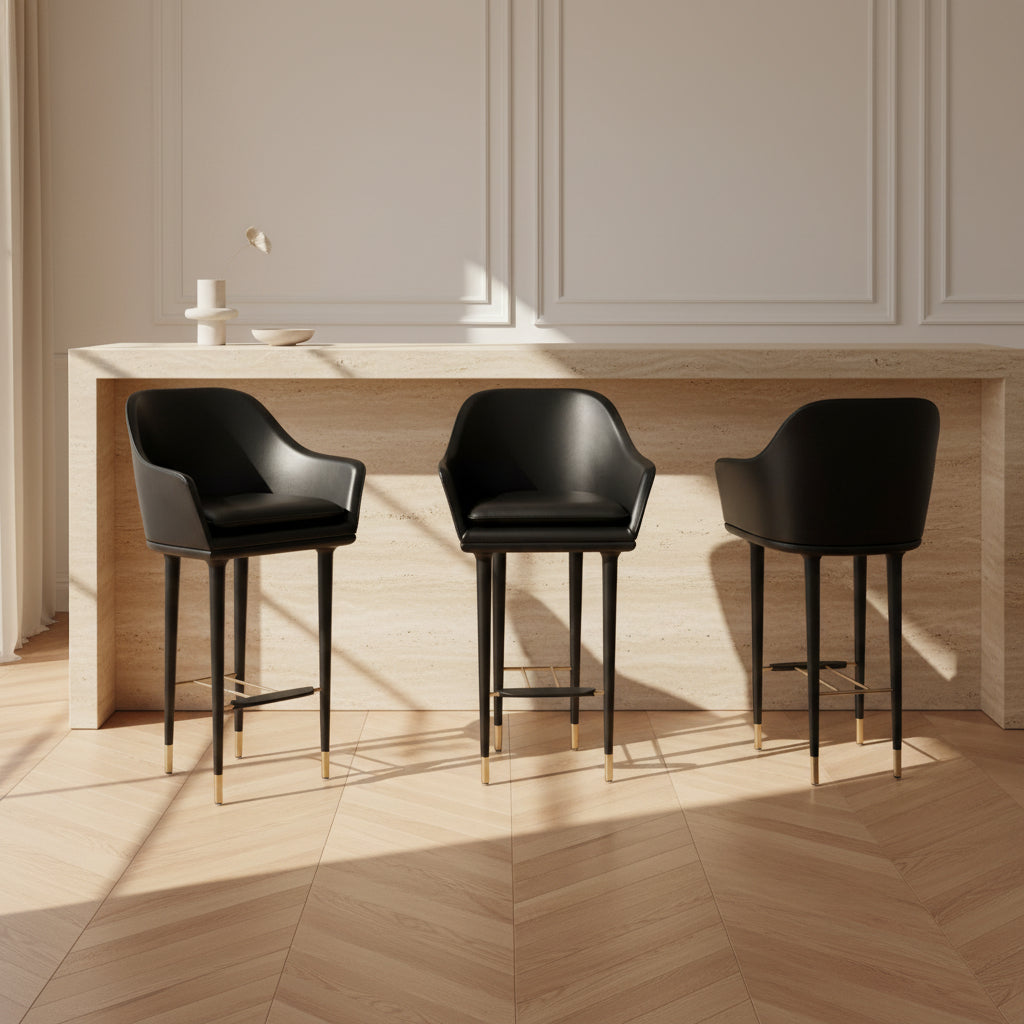 A set of three Stellar Works Lunar Bar Chairs by Steller Works, featuring black leather upholstery, armrests, and gold accents, is arranged in a row against a plain white background.