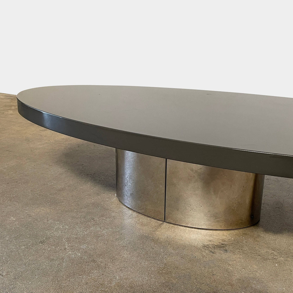 A sleek Minotti Raymond Coffee Table with a metal base, exhibiting clean shapes and proportions.