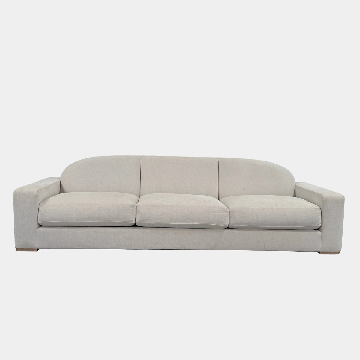 The Dmitriy & Co. Erato Sofa by Dimitriy & Co is a light gray three-seater featuring low arms and wooden feet, showcased against a plain white background—an elegant example of bespoke furnishings and couture upholstery.