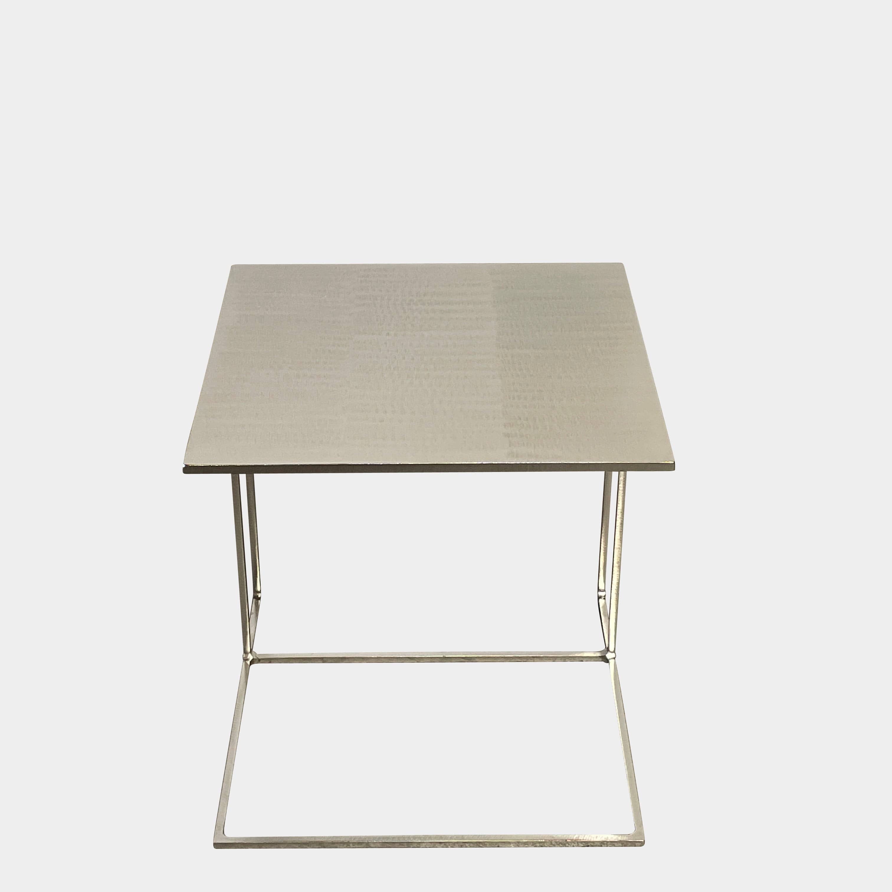 The Minotti Leger Side Table, by Minotti, features a metallic accent with its metal frame, creating a clean and minimal design against a white background.