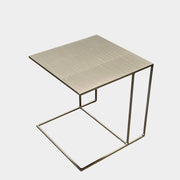The Minotti Leger Side Table, by Minotti, features a metallic accent with its metal frame, creating a clean and minimal design against a white background.