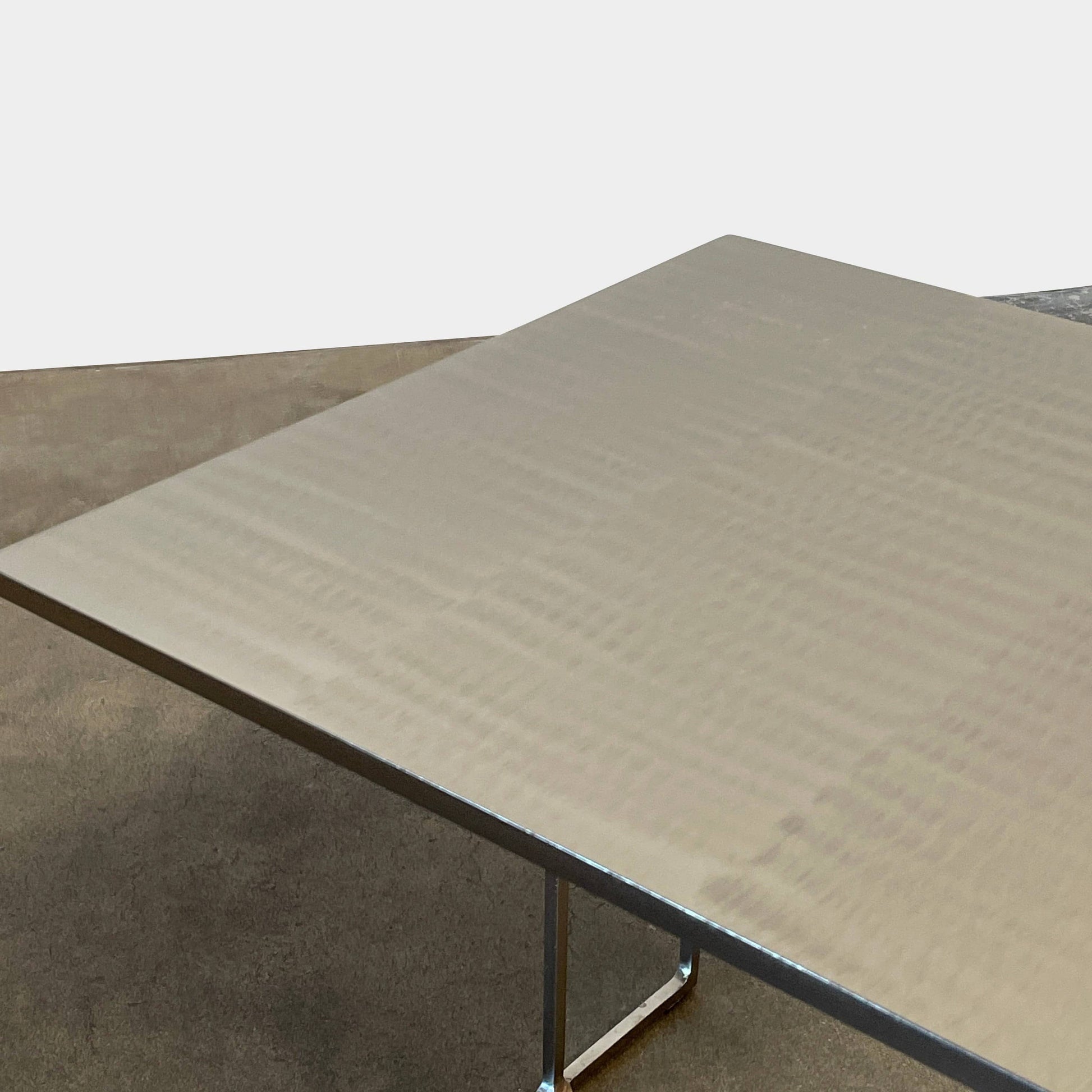 The Minotti Leger Side Table, by Minotti, features a metallic accent with its metal frame, creating a clean and minimal design against a white background.