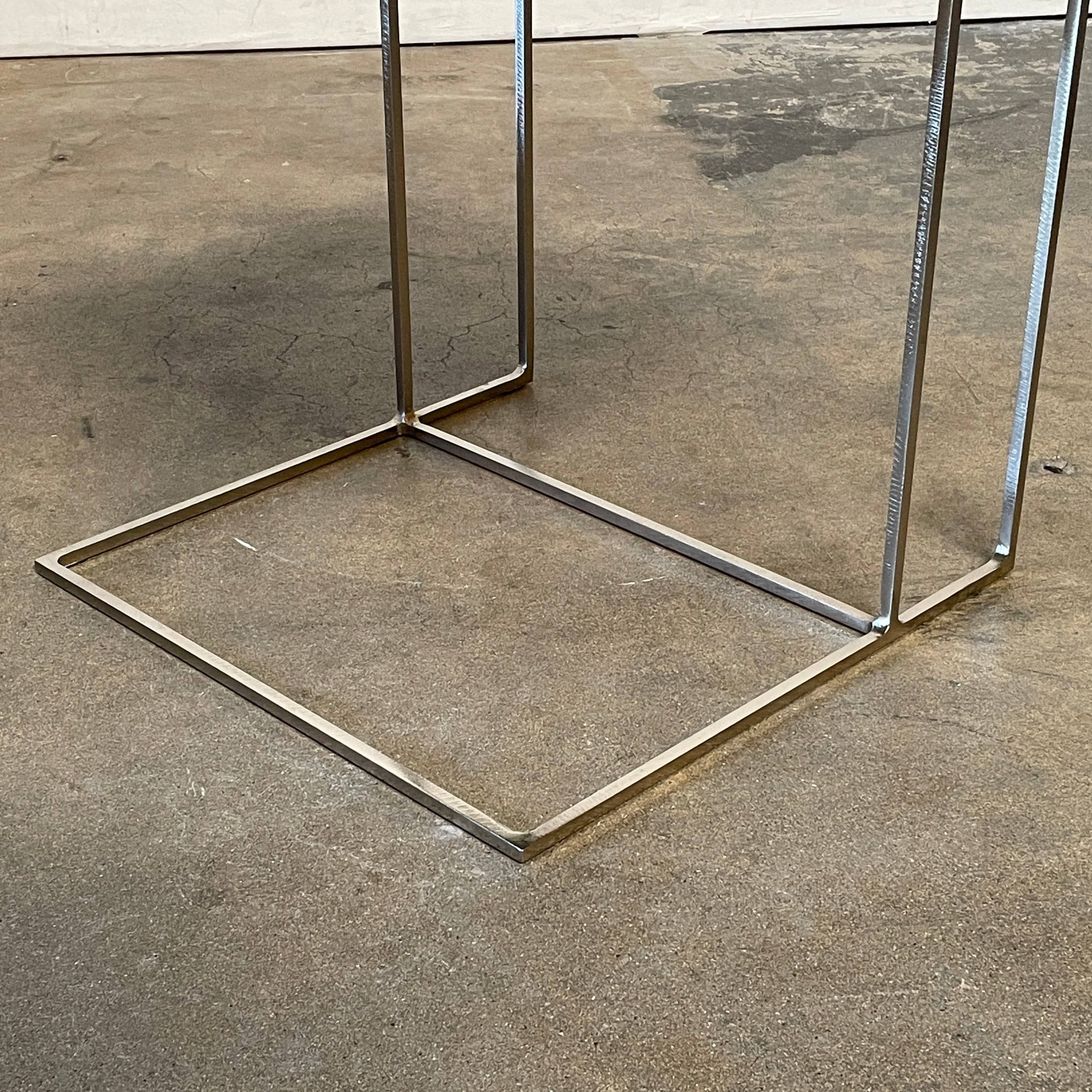 The Minotti Leger Side Table, by Minotti, features a metallic accent with its metal frame, creating a clean and minimal design against a white background.