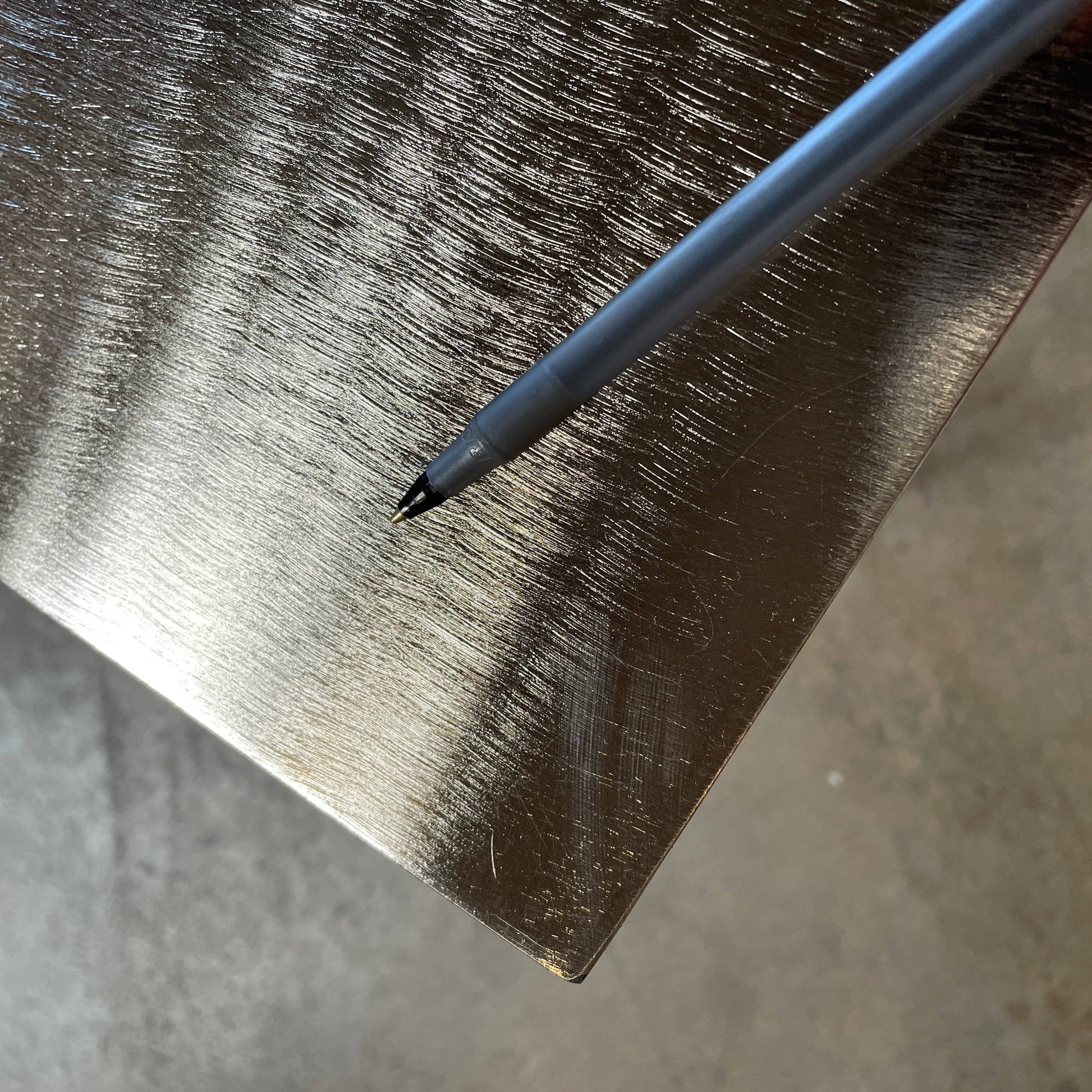 The Minotti Leger Side Table, by Minotti, features a metallic accent with its metal frame, creating a clean and minimal design against a white background.