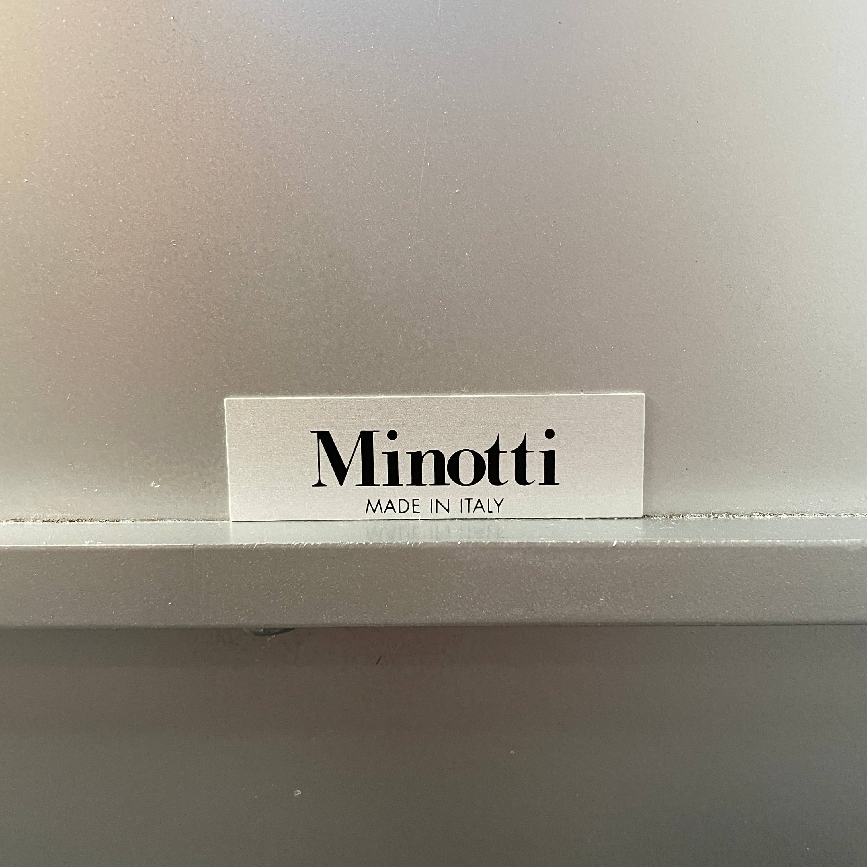 The Minotti Leger Side Table, by Minotti, features a metallic accent with its metal frame, creating a clean and minimal design against a white background.