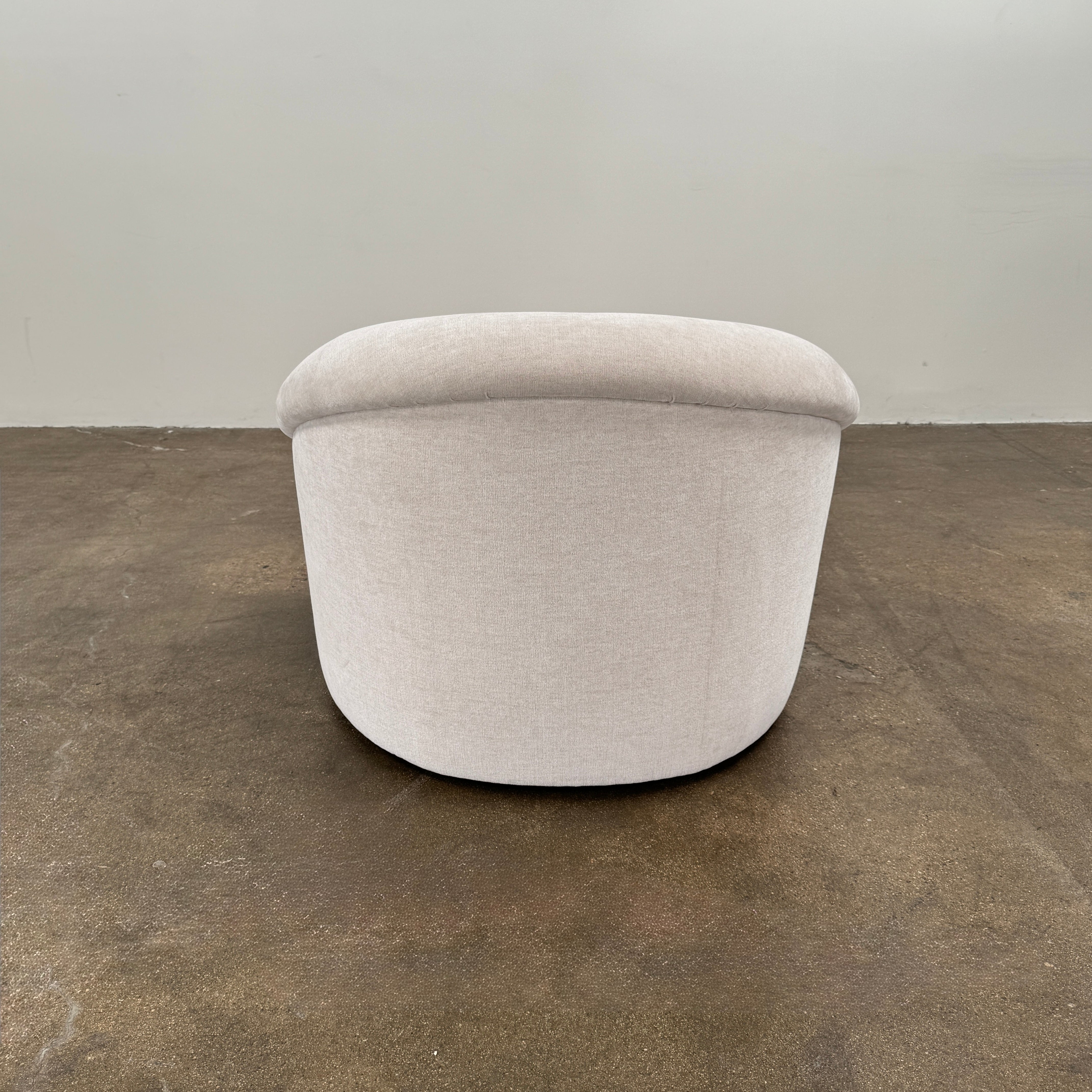 Certainly! Here’s a rewritten version of the sentence using your product data: The Vintage Chair + Ottoman – In The Style of Steve Chase by Vintage, featuring beige upholstery with rounded edges and a matching oval ottoman, both set against a plain white background, evoke the timeless elegance of mid-century modern furniture.
