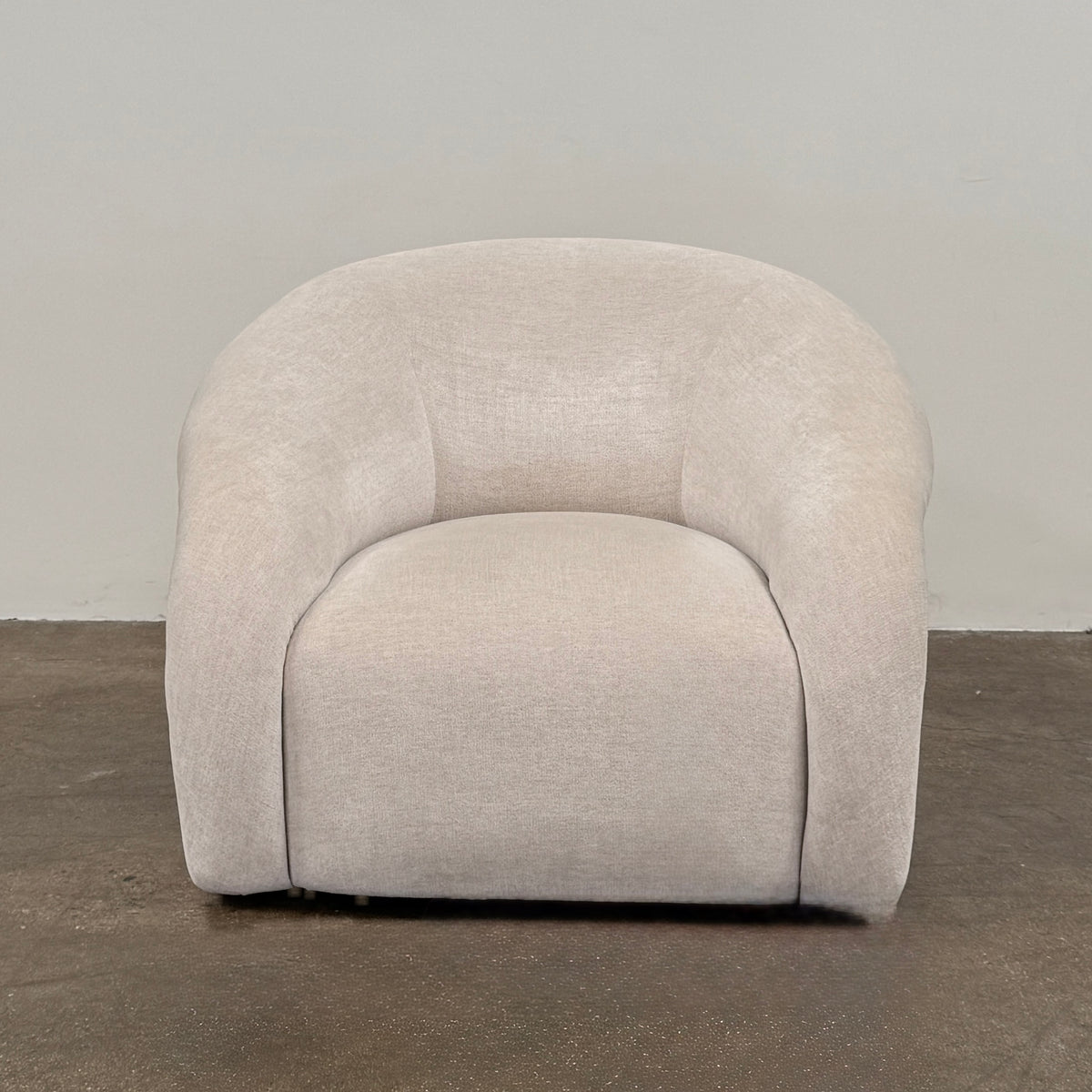 Certainly! Here’s a rewritten version of the sentence using your product data: The Vintage Chair + Ottoman – In The Style of Steve Chase by Vintage, featuring beige upholstery with rounded edges and a matching oval ottoman, both set against a plain white background, evoke the timeless elegance of mid-century modern furniture.