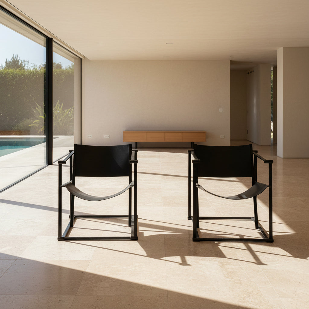 Two black Vintage Pastoe FM62 Chairs by Pastoe, inspired by constructivist design, are placed on a tile floor in a spacious, minimal living room with large windows overlooking a pool and greenery outside.