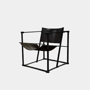 Two black Vintage Pastoe FM62 Chairs by Pastoe, inspired by constructivist design, are placed on a tile floor in a spacious, minimal living room with large windows overlooking a pool and greenery outside.