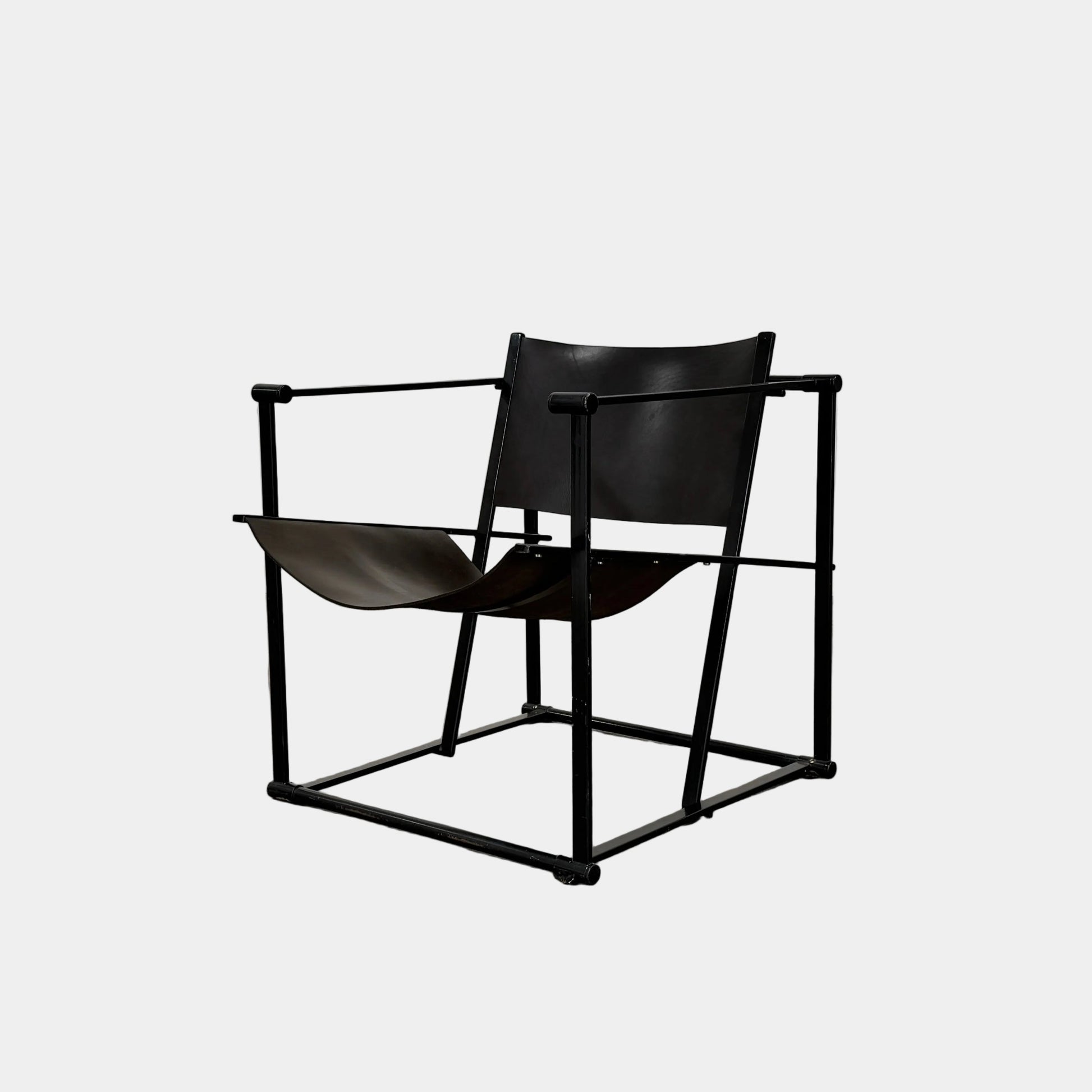 Two black Vintage Pastoe FM62 Chairs by Pastoe, inspired by constructivist design, are placed on a tile floor in a spacious, minimal living room with large windows overlooking a pool and greenery outside.