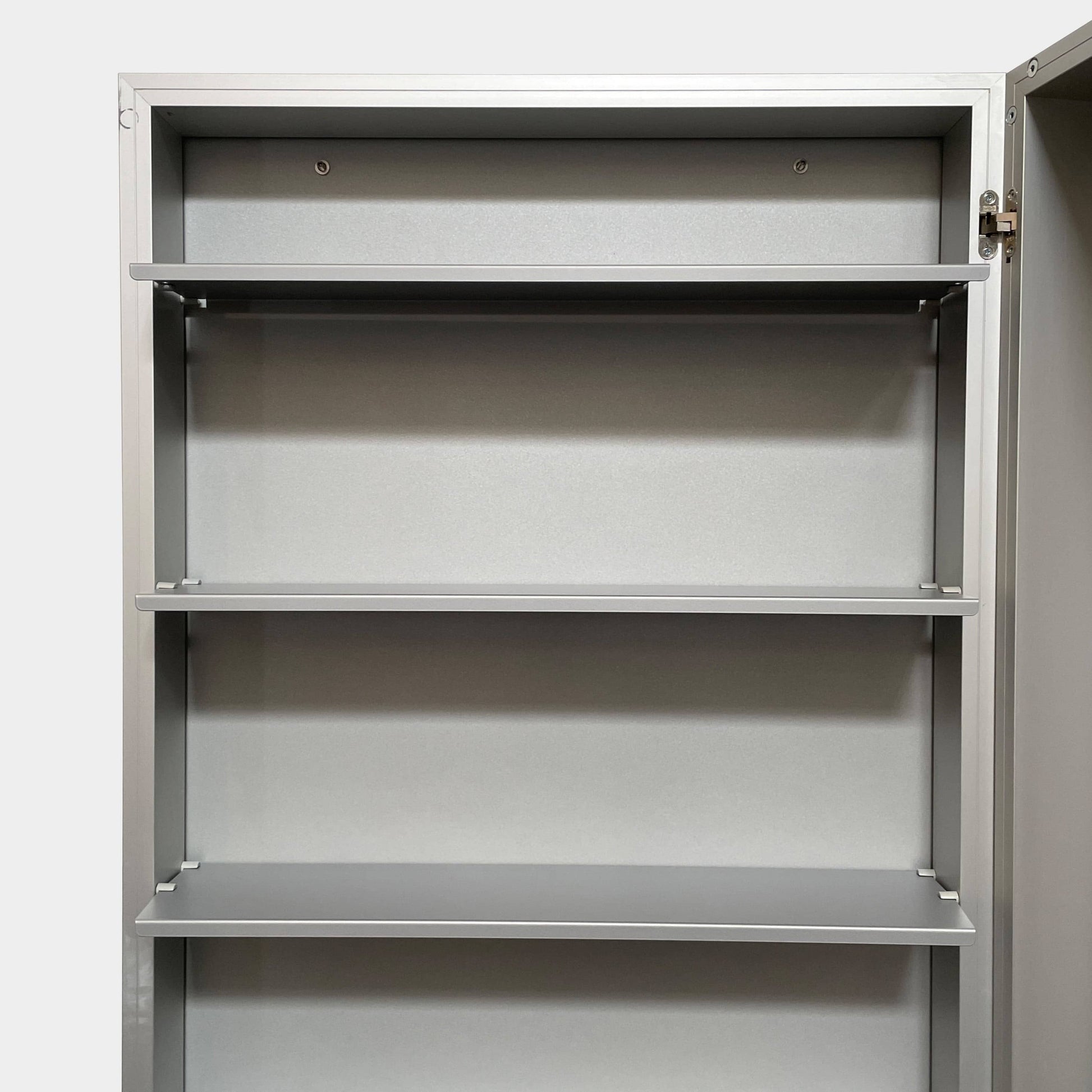 A Bellato Box Mirror Cabinet, featuring a rectangular, full-length design with a thin silver frame, stands elegantly against a plain light gray background.