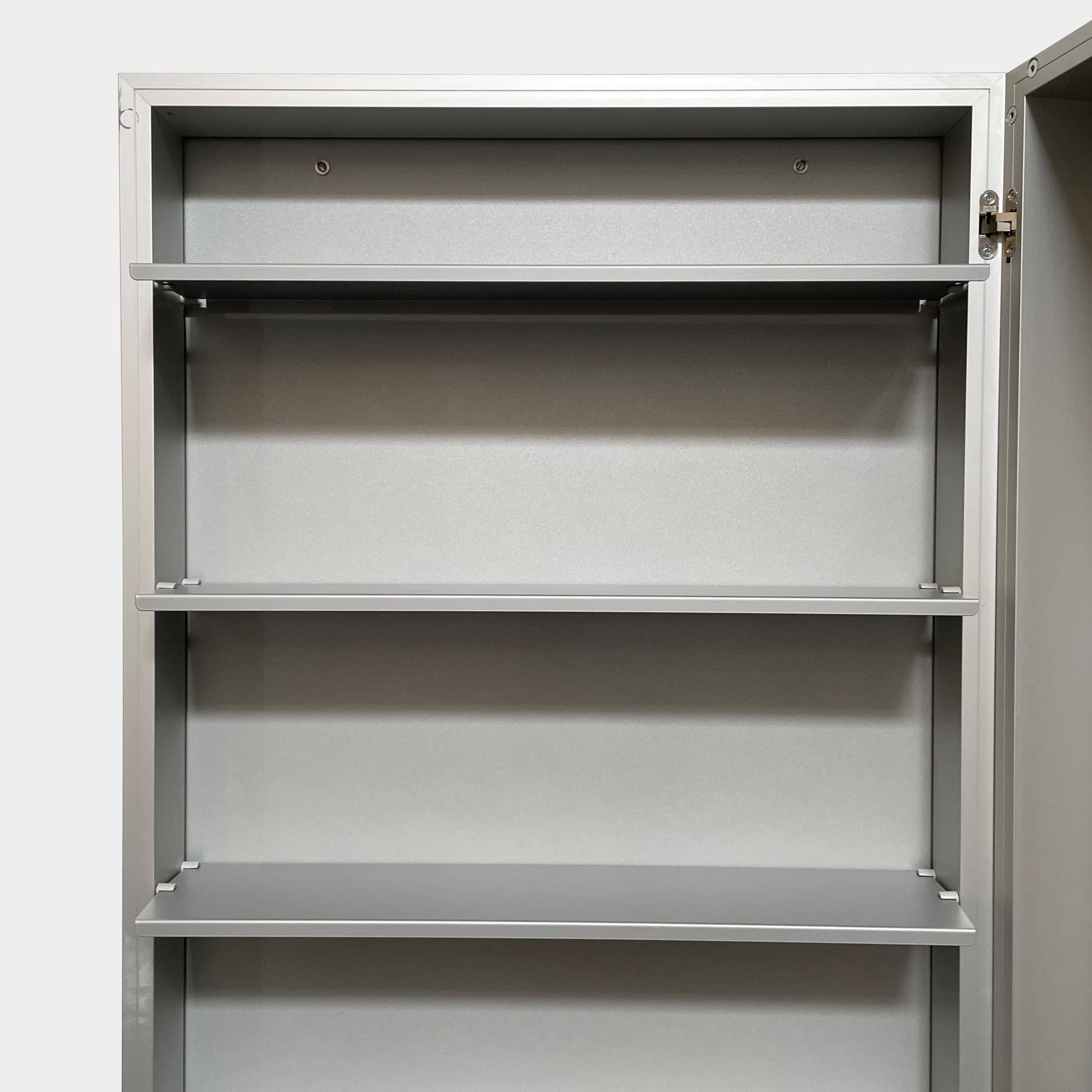 A Bellato Box Mirror Cabinet, featuring a rectangular, full-length design with a thin silver frame, stands elegantly against a plain light gray background.