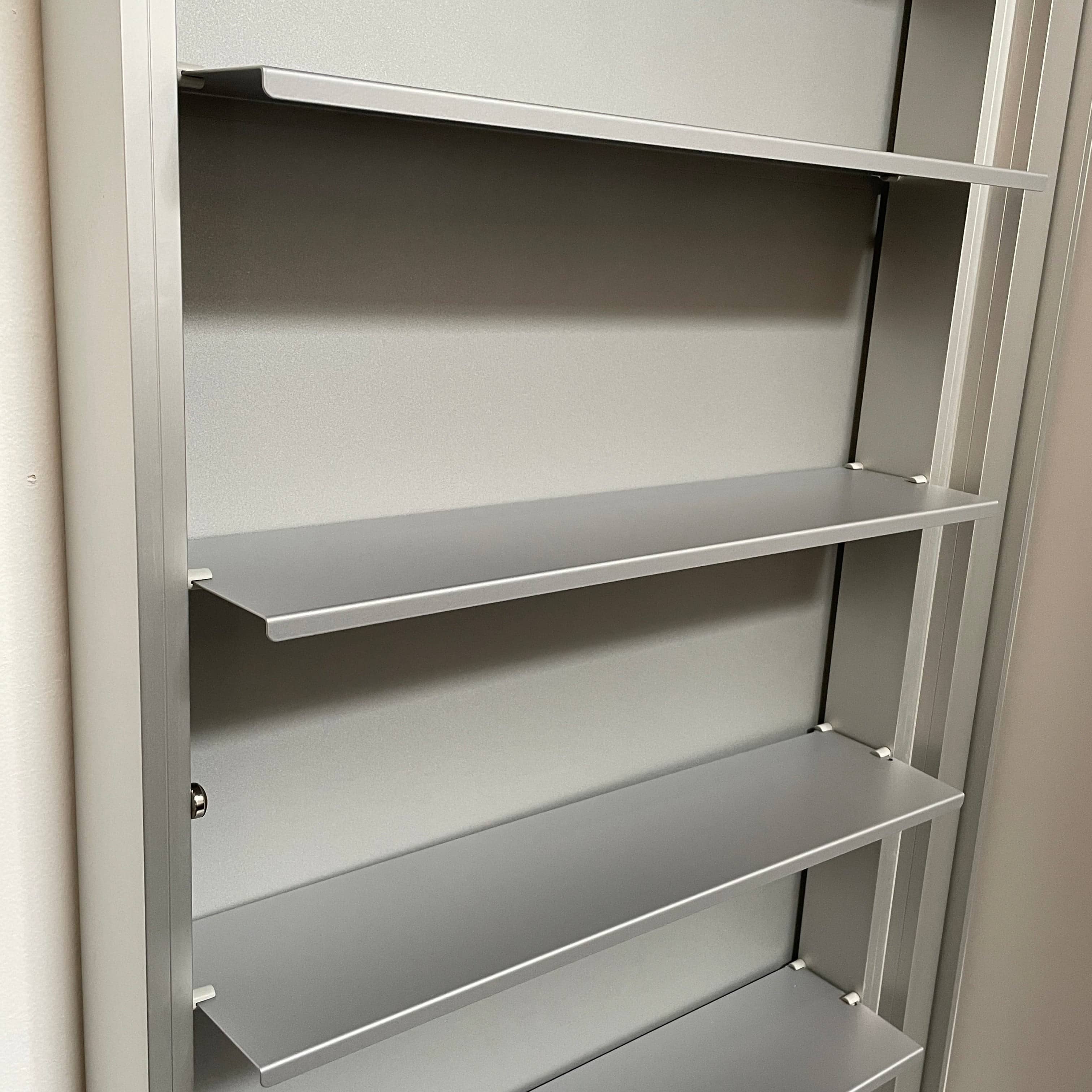 A Bellato Box Mirror Cabinet, featuring a rectangular, full-length design with a thin silver frame, stands elegantly against a plain light gray background.