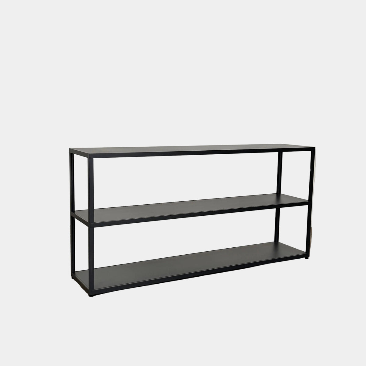 The Hay New Order System Shelves by Hay is a black, metal-framed, two-shelf open bookcase featuring a minimalist design inspired by Scandinavian aesthetics, shown against a plain white background.