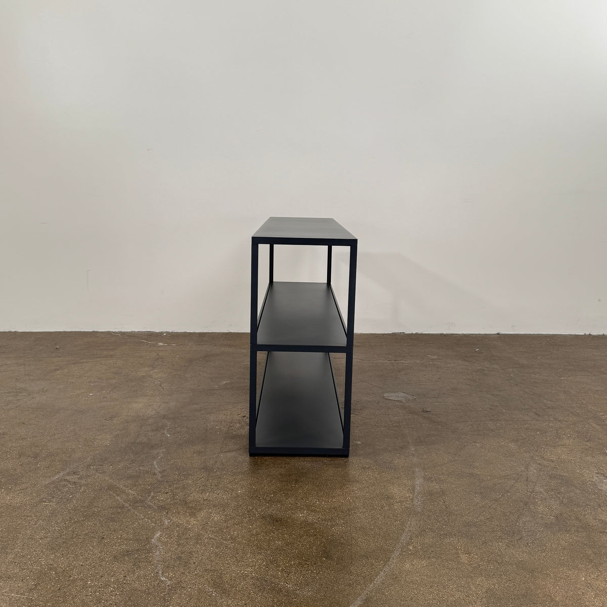 The Hay New Order System Shelves by Hay is a black, metal-framed, two-shelf open bookcase featuring a minimalist design inspired by Scandinavian aesthetics, shown against a plain white background.