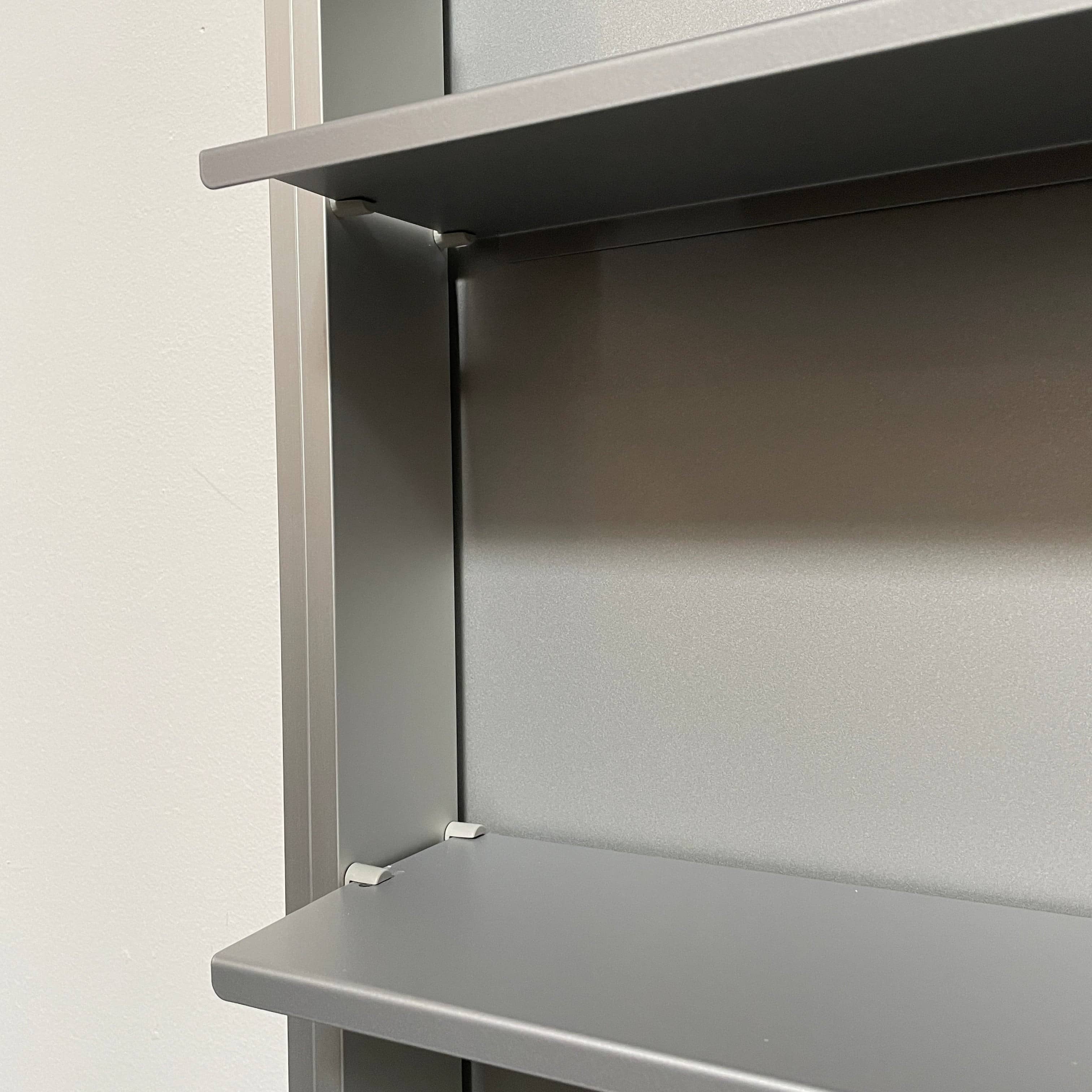 A Bellato Box Mirror Cabinet, featuring a rectangular, full-length design with a thin silver frame, stands elegantly against a plain light gray background.
