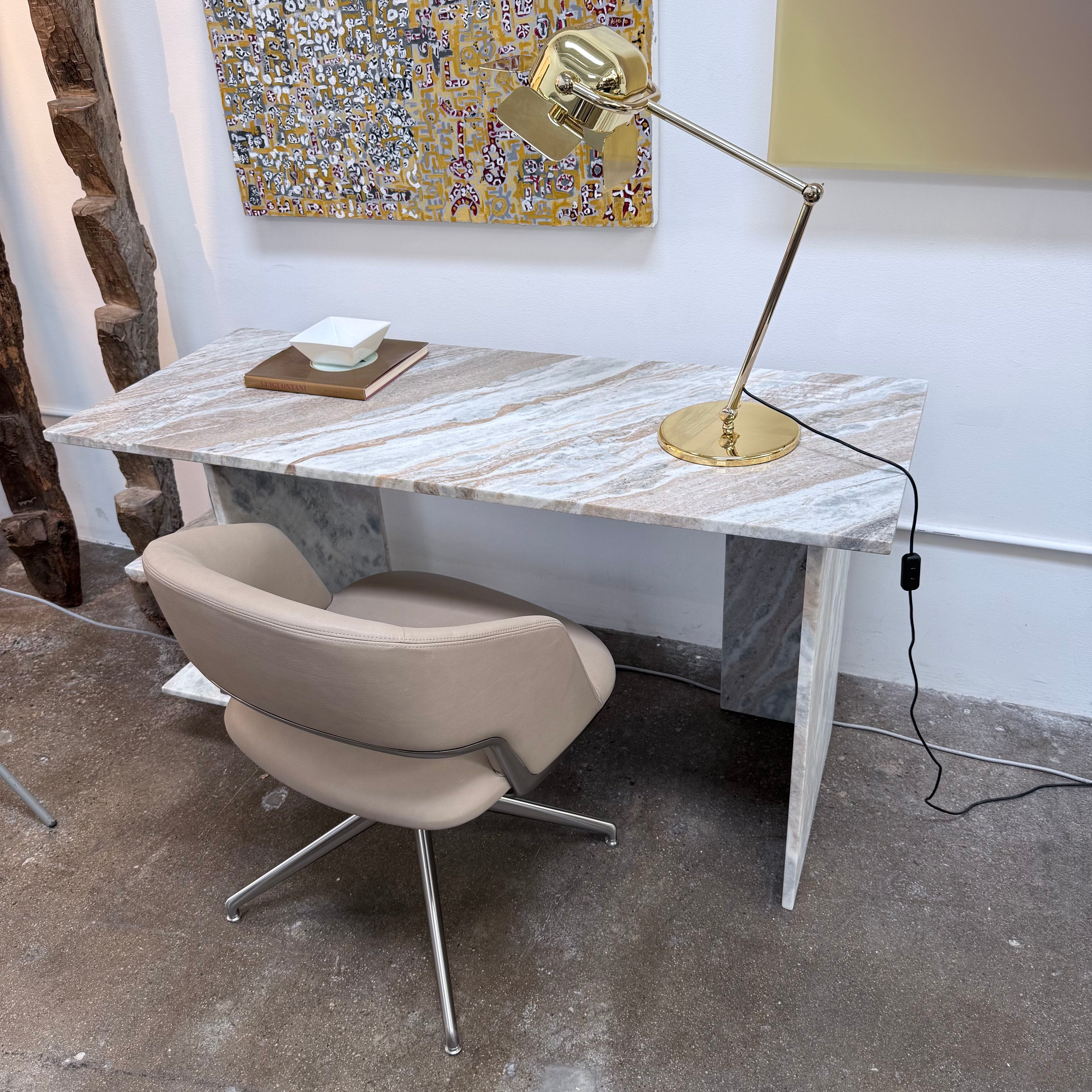 The CB2 Hera Torrento Brown Marble Desk with Shelves features two side panels and two open left corner shelves, showcasing a light gray and beige pattern inspired by Torrento brown marble.