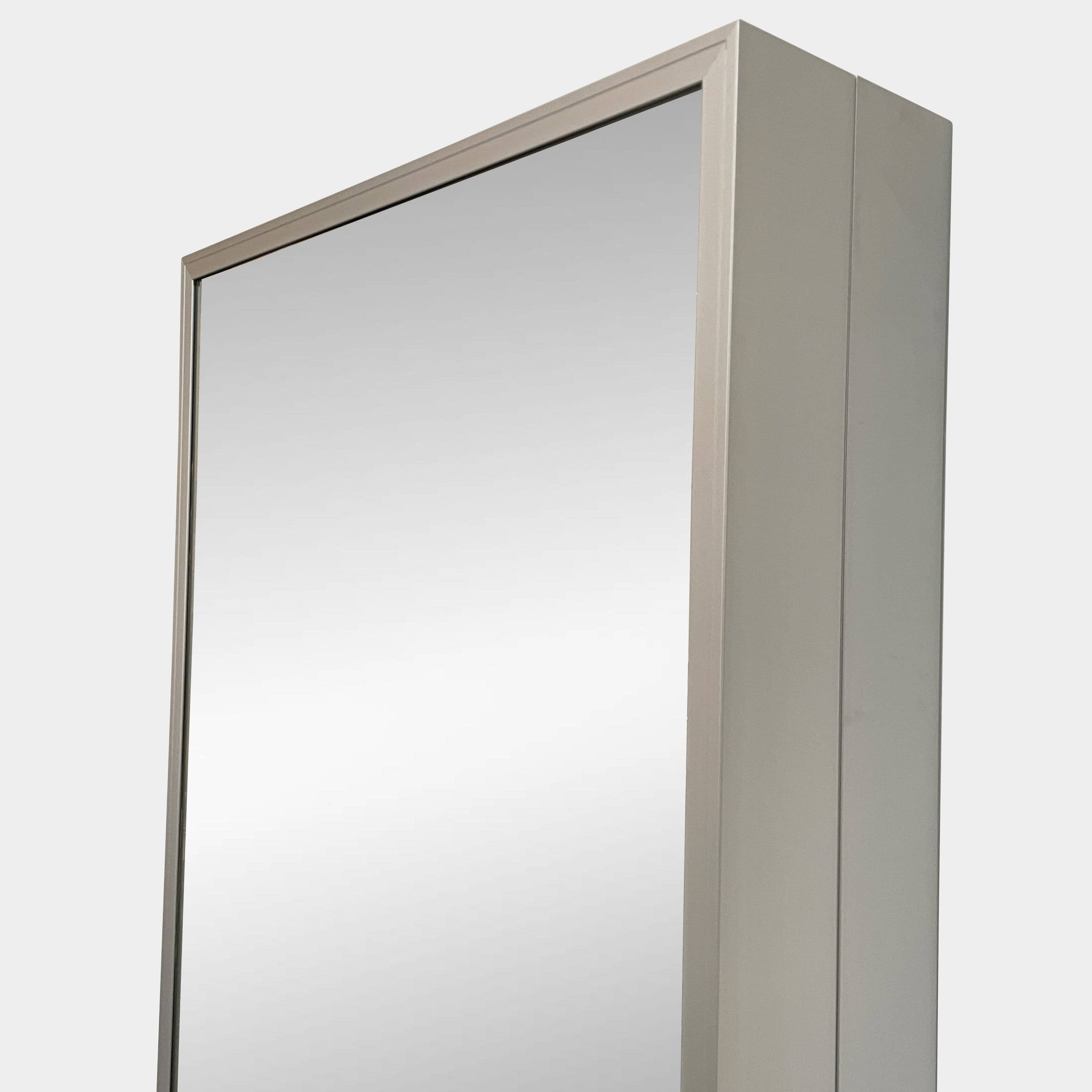 A Bellato Box Mirror Cabinet, featuring a rectangular, full-length design with a thin silver frame, stands elegantly against a plain light gray background.