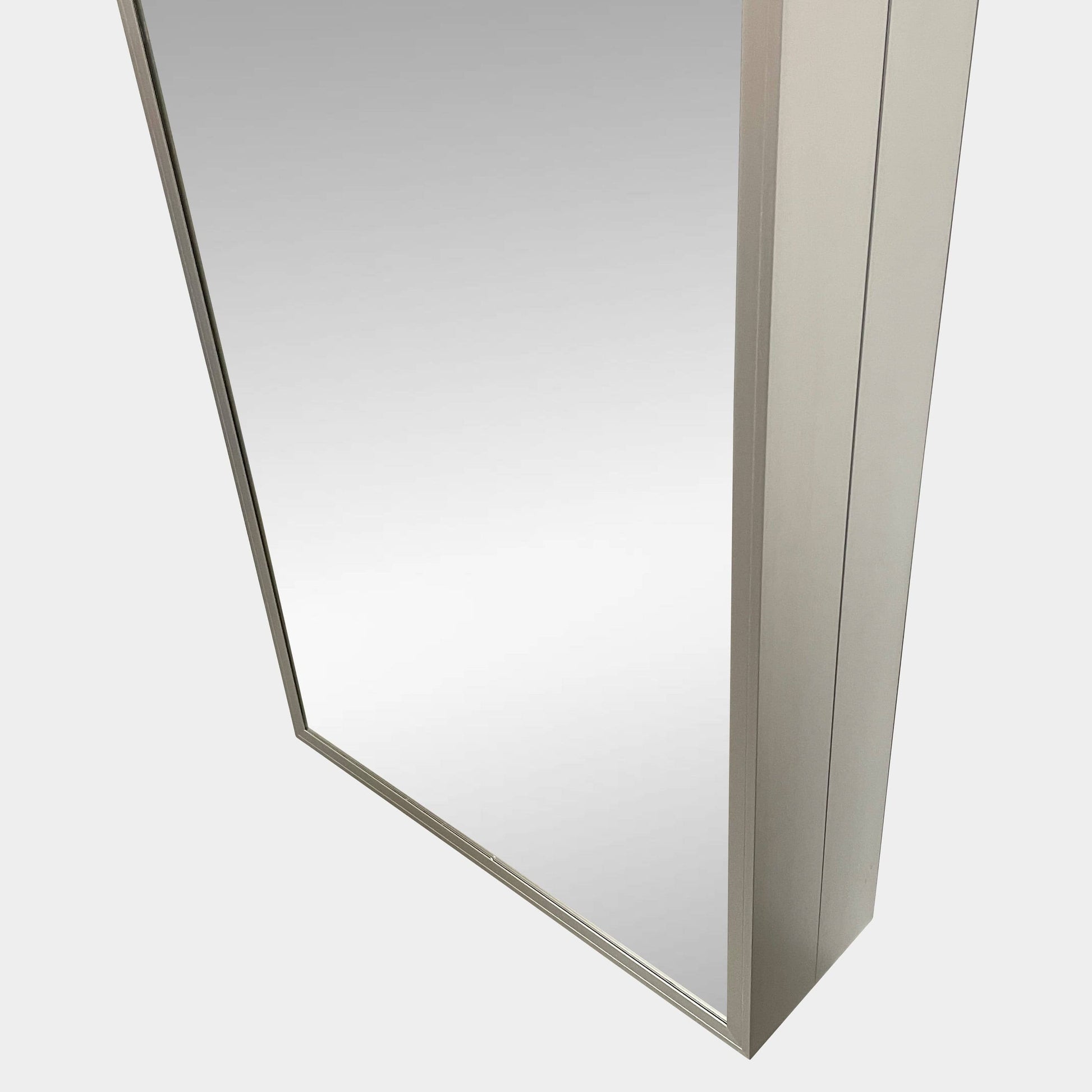 A Bellato Box Mirror Cabinet, featuring a rectangular, full-length design with a thin silver frame, stands elegantly against a plain light gray background.