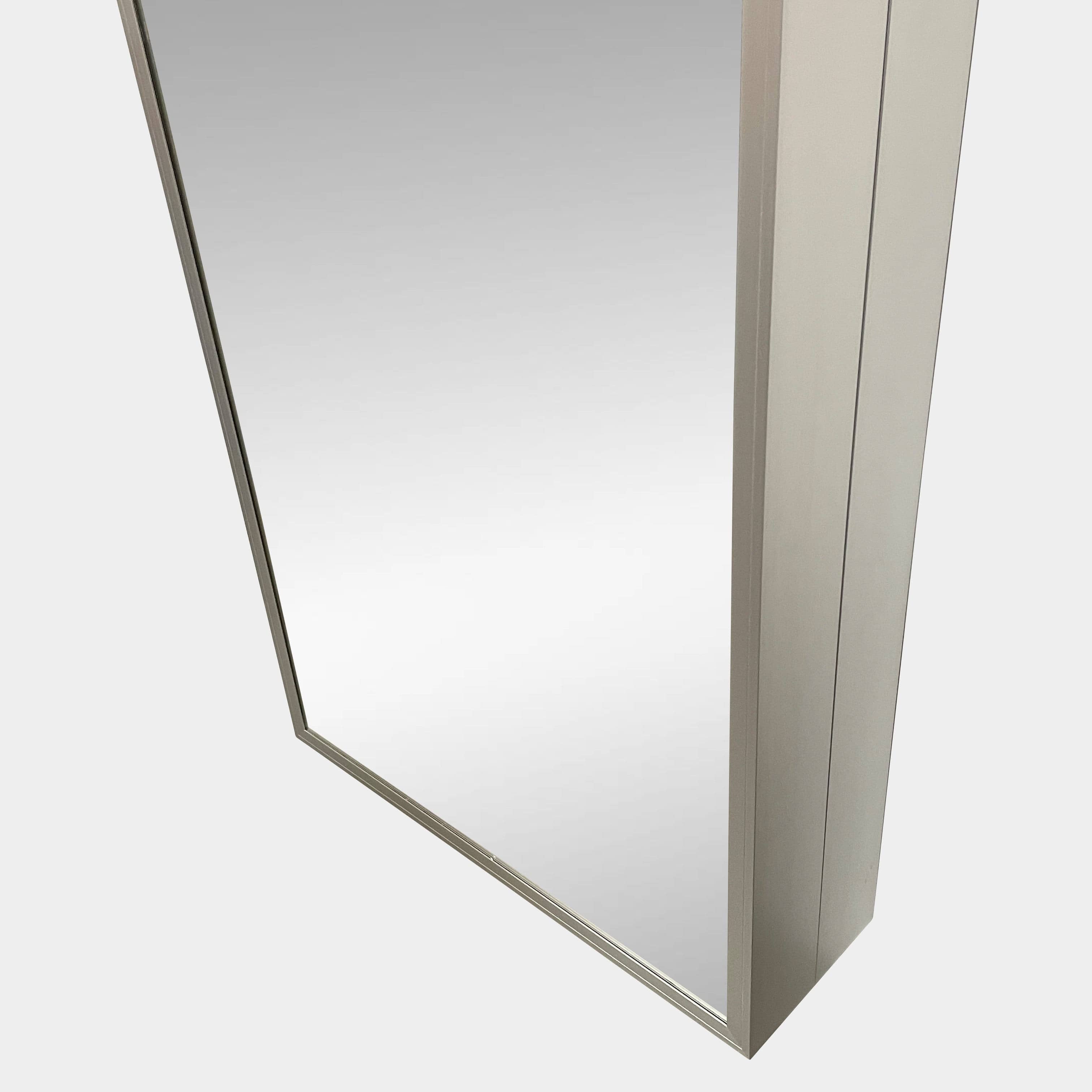 A Bellato Box Mirror Cabinet, featuring a rectangular, full-length design with a thin silver frame, stands elegantly against a plain light gray background.