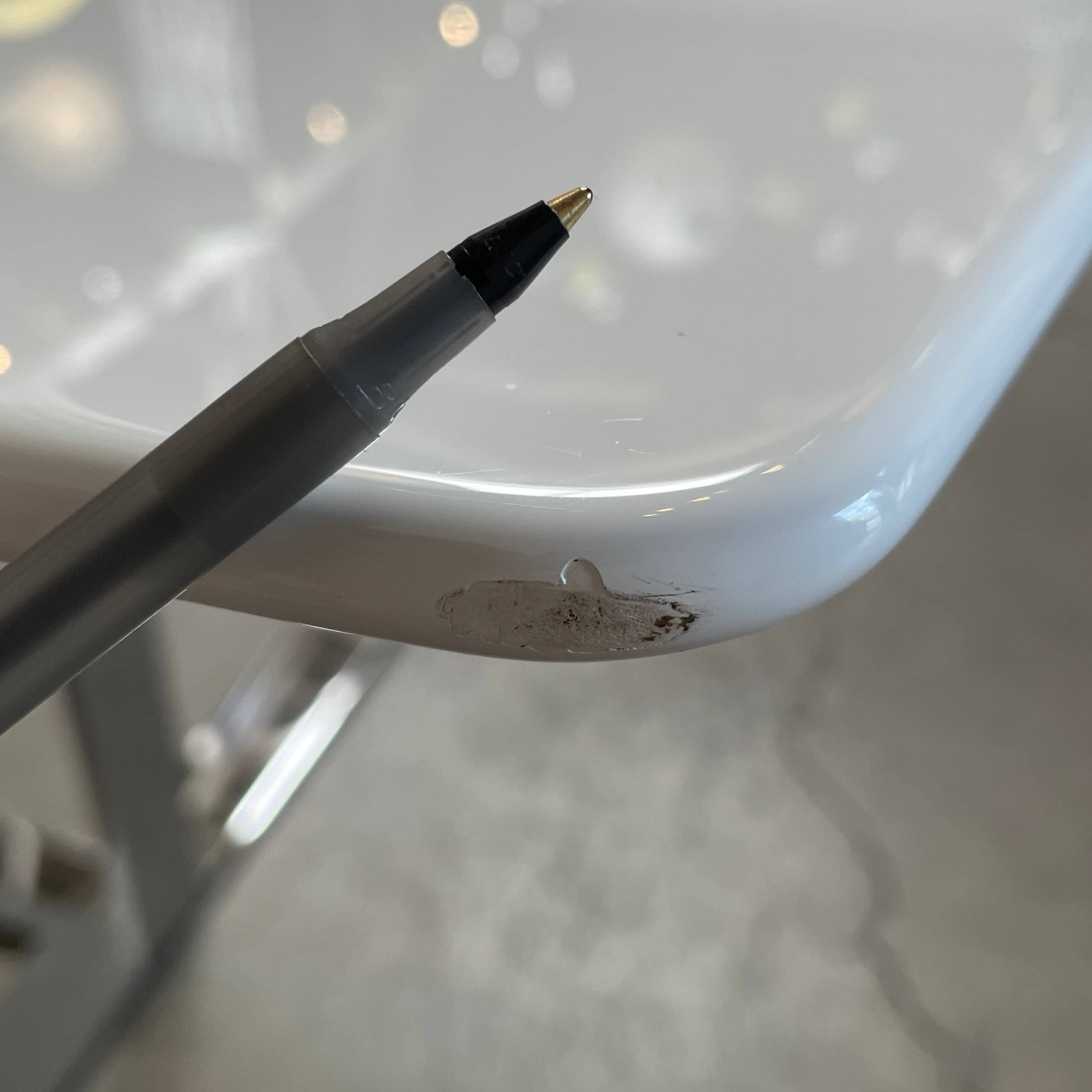 A minimalist rectangular B&B Italia Eileen White Dining Table featuring a sophisticated T-shaped metal base on a plain white background.