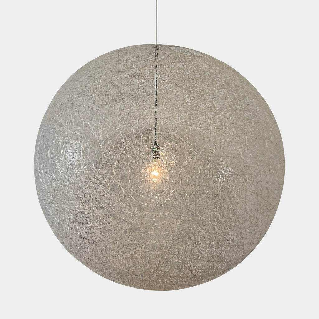 A Moooi Random Pendant suspension light with a white ball, reminiscent of the Moooi Random design, hanging from a light fixture.