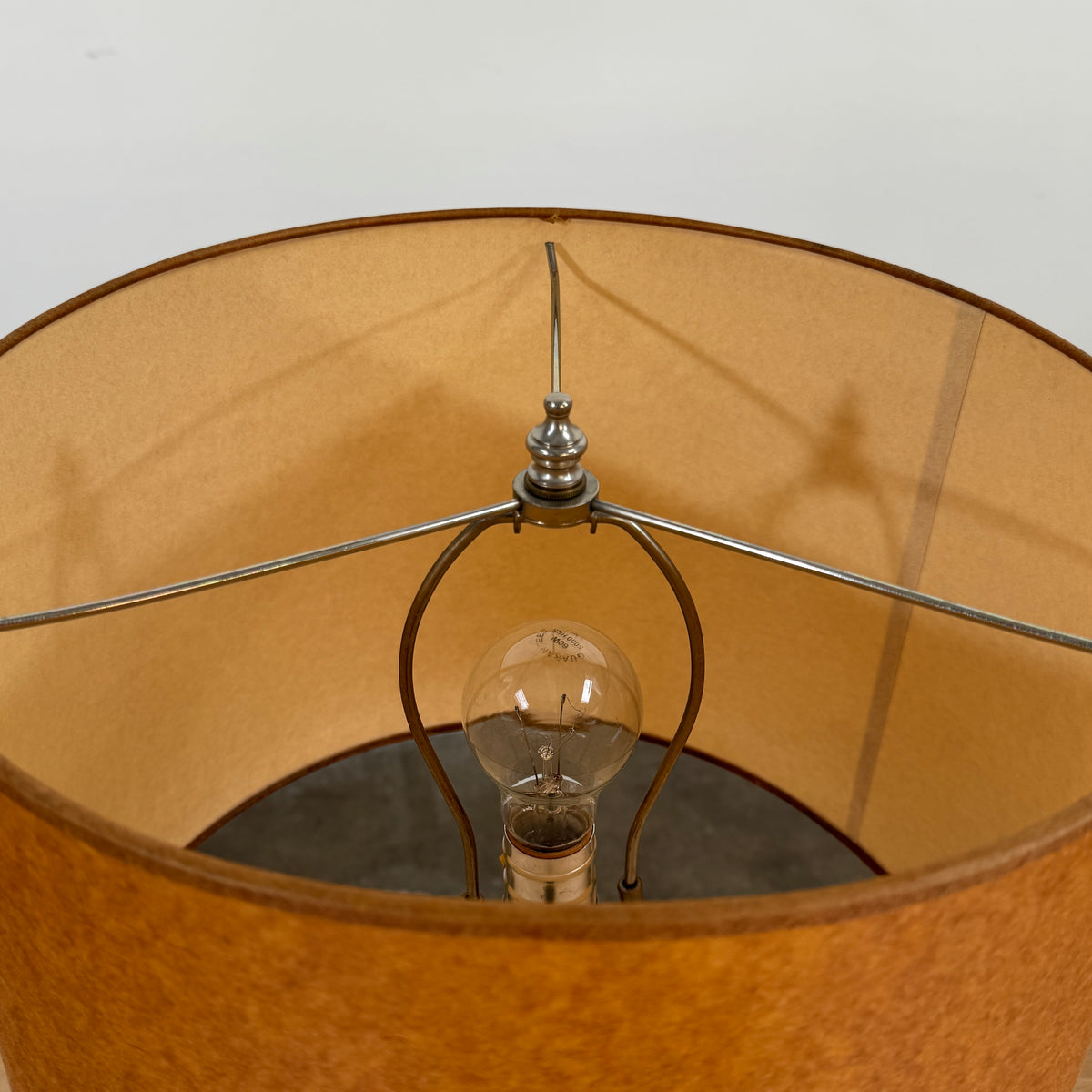 Two Shelter Brasilia Lamp by Modern Resale with textured white bases and orange cylindrical shades are displayed on a beige stone surface against a gray background.